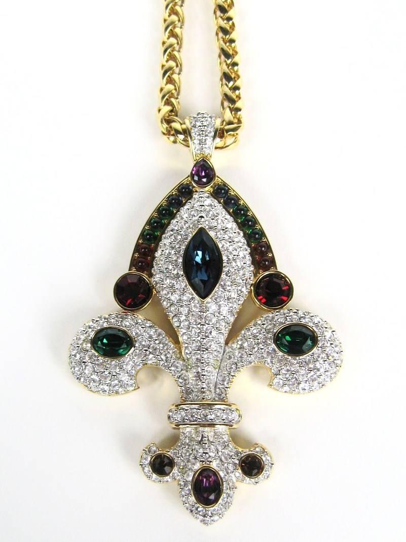 Swarovski Massive Fleur De Lis Pendant with 29 inch long chain. This Beautiful Pendant has pave set with clear stones and has Marquis shaped crystals in colors Blue, green, Purple and amber round bezel set red stones with a oval bezel set stone.
