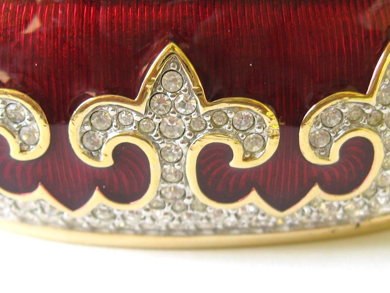 Heavy high quality Swarovski cuff bracelet with a deep glowing Red GUILLOCHE background and accented with crystal fleur de lis. The inside of the cuff is marked with the famous Swarovski Swan logo.  Swarovski made in the 1980s. Bracelet measures