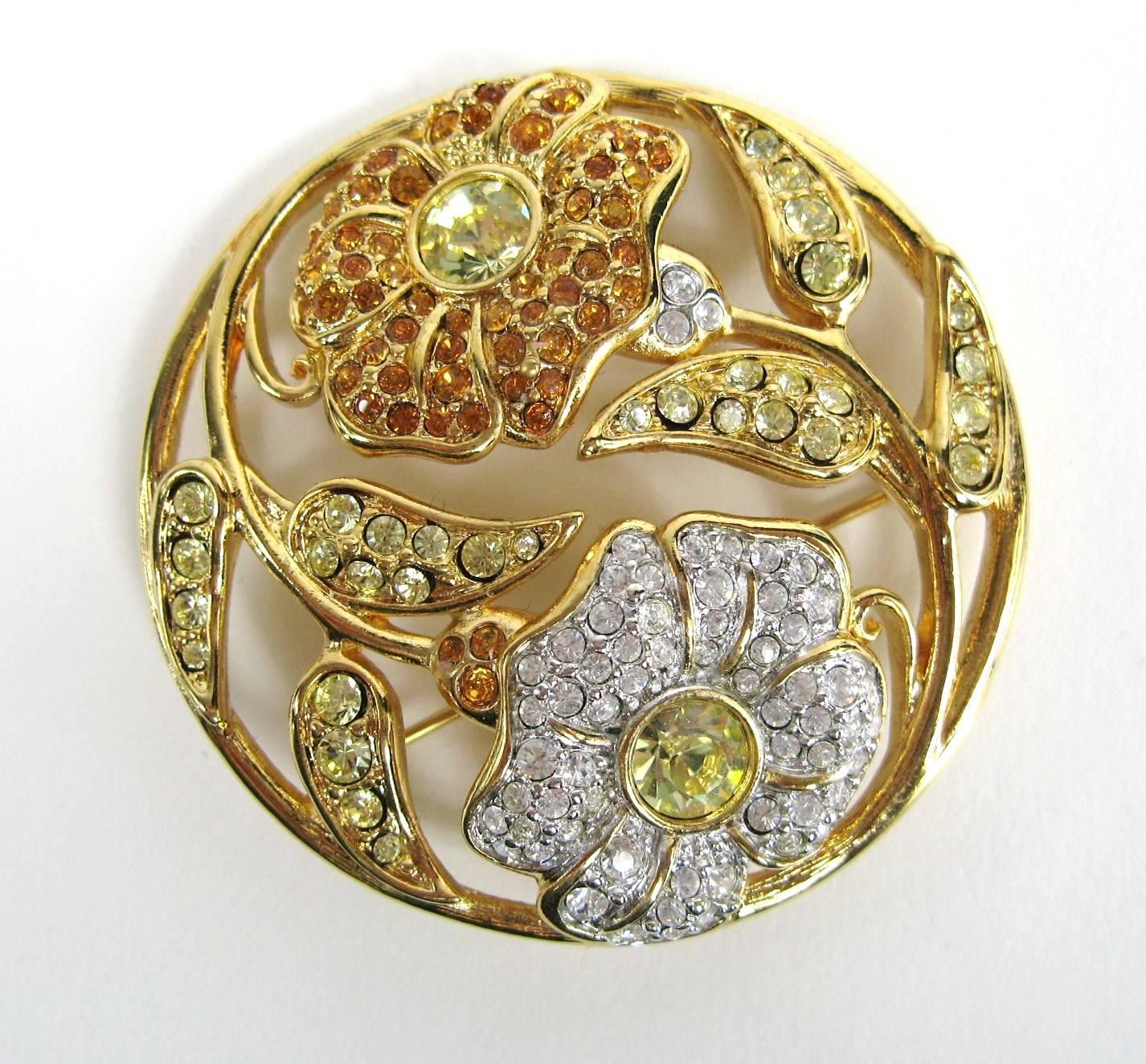 Stunning circle Swarovski Floral Brooch Amber and clear Crystal flowers. Measuring 1.90 in / 48.84 mm. This Comes in original Box. This is out of a massive collection of Hopi, Zuni, Navajo, Southwestern, sterling silver, costume jewelry and fine