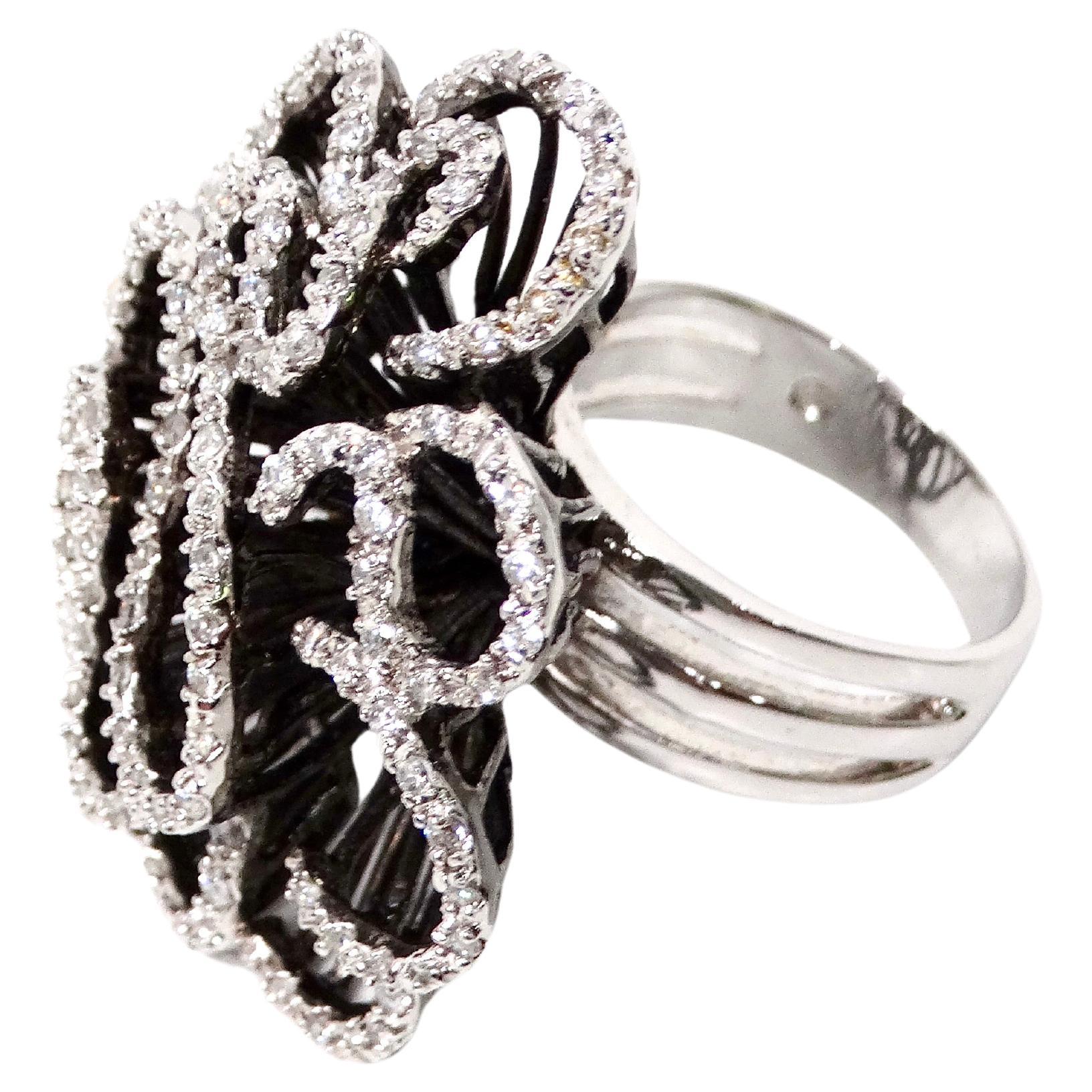 The Swarovski Crystal Flower Style 925 Silver Cocktail Ring is a stunning statement piece that beautifully combines elegance and artistry. Crafted from high-quality sterling silver, the ring features a delicately designed flower motif encrusted with