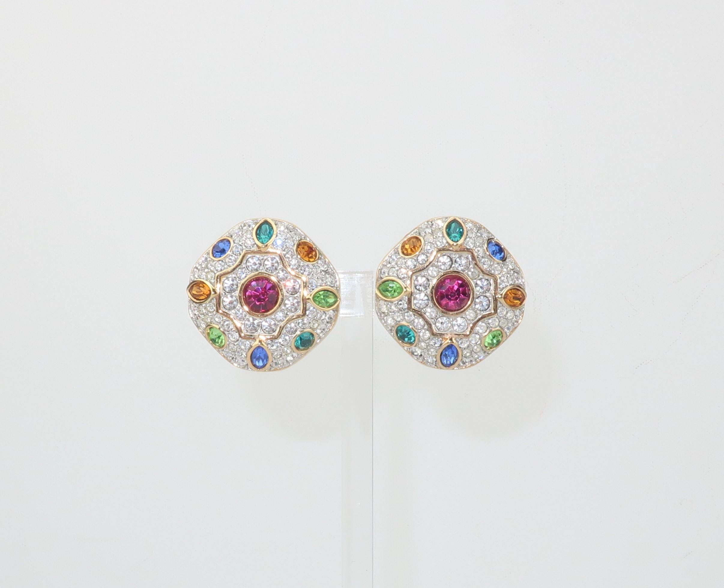 A beautiful pair of gold tone earrings embellished with Swarovski sparkling crystal rhinestones in multi color shades of ruby red, sapphire blue, aquamarine, citrine yellow and peridot green.  Outfitted with clip on hardware and signed with the
