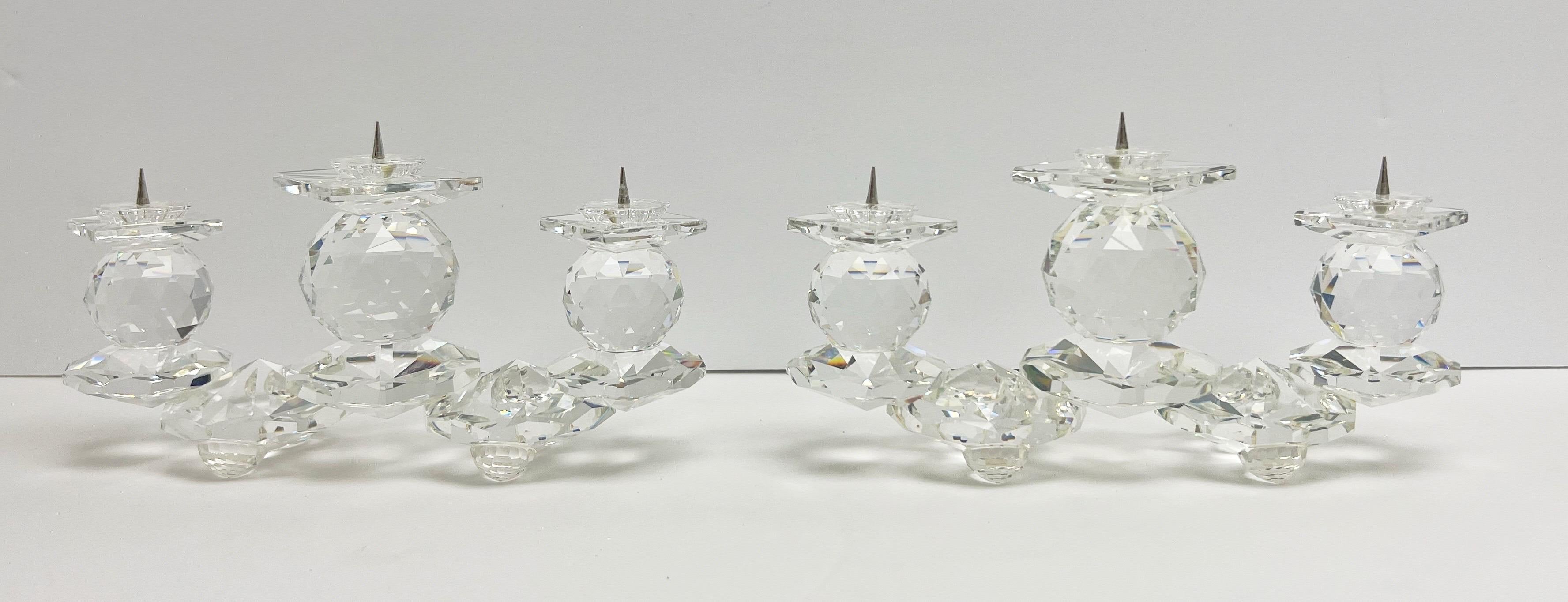 A pair of crystal Swarovski candleholders. 