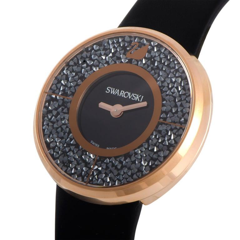 The Crystalline watch by Swarovski, reference number 5105127, is presented with a rose gold PVD-coated stainless steel case that boasts a 40 mm diameter. The case is filled with approximately 800 Jet Hematite crystals that frame the black dial. On