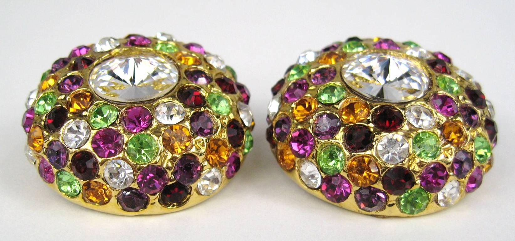 Massive round clip-on crystal earrings, these have a wonderful mix of colors with a huge clear crystal in the center. Measuring 1.5 in. Unsigned, however, they came with a matching brooch that was signed. The last photo is the back side of the