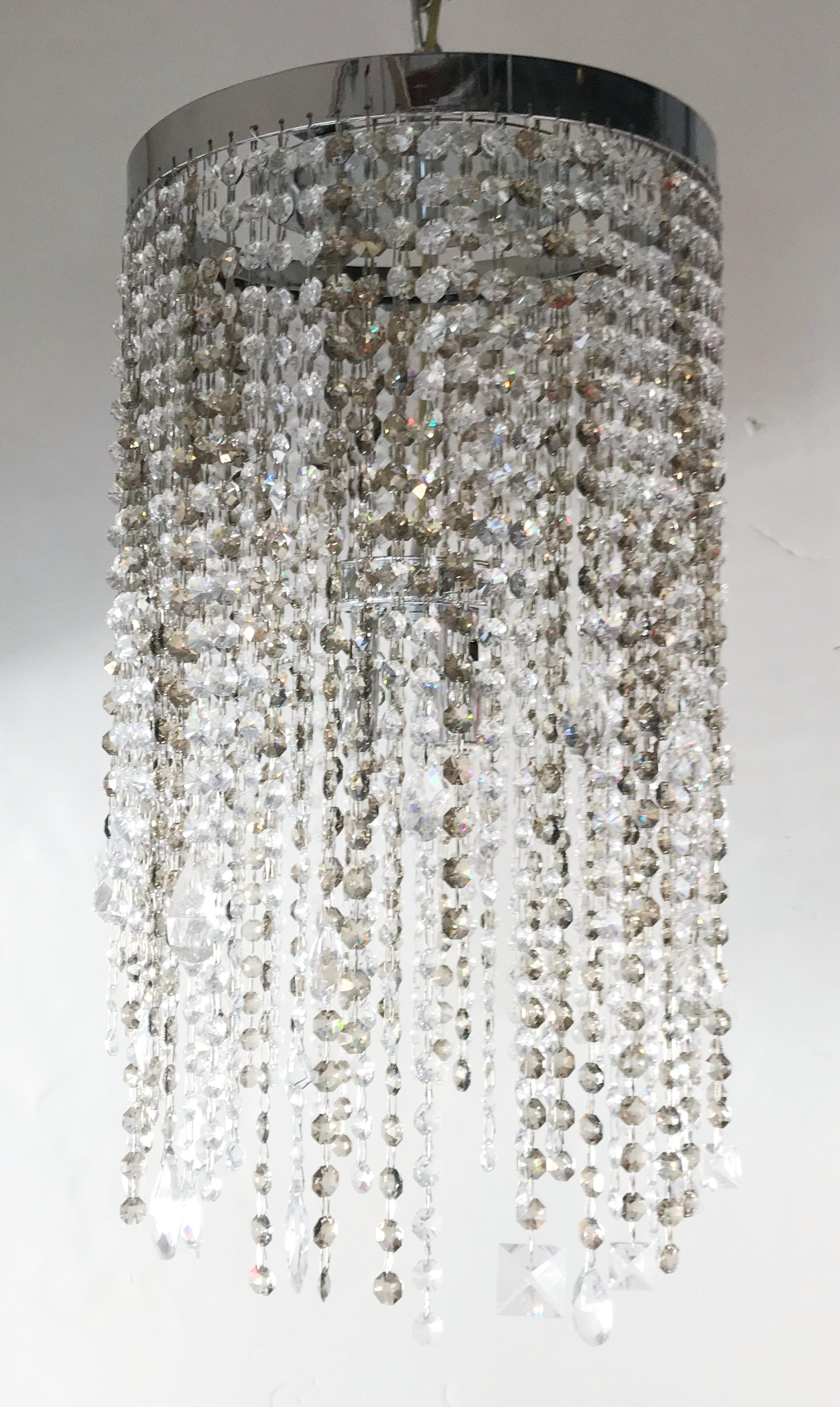 Elegant Italian flush mount with strings of smoky and clear octagonal Swarovski crystals mixed with other larger crystals in various shapes / Made in Italy
3 lights / G9 type / max 40W each
Diameter: 13.5 inches / Height: 23 inches
1 in stock in