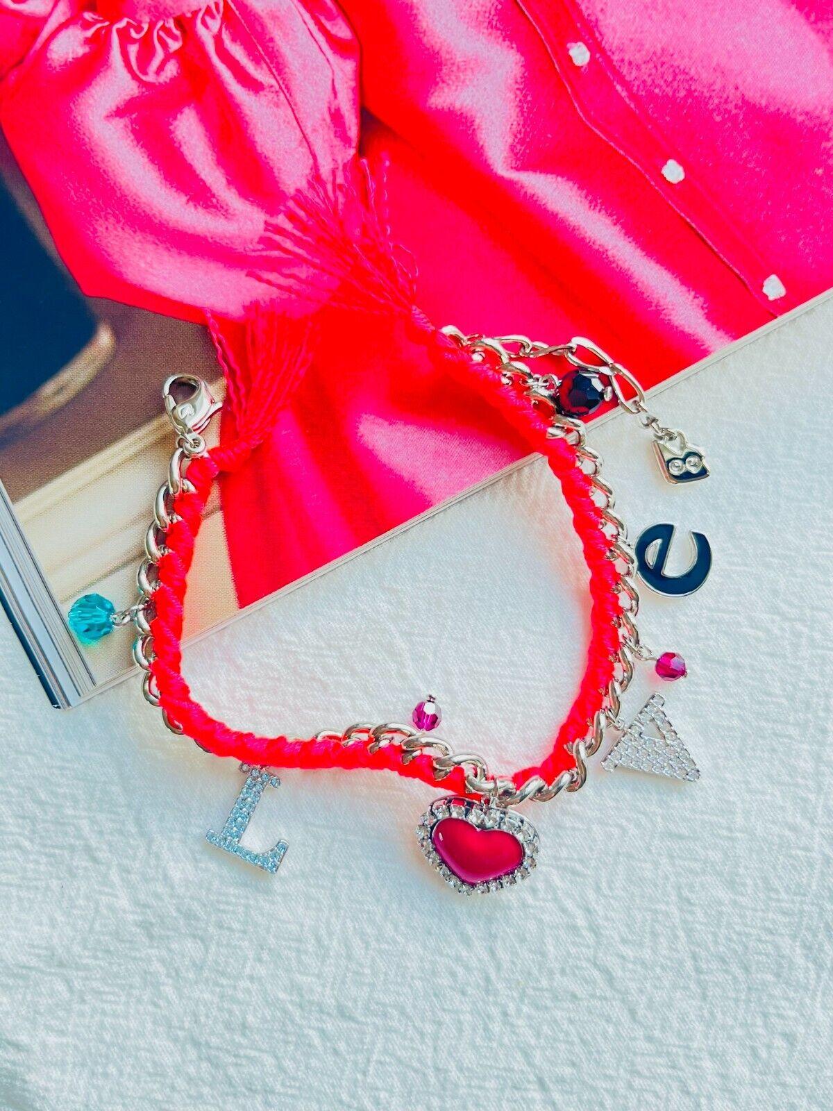Swarovski Love Heart Charm Alphabet Shining Crystals Pink Red Bracelet Silver Tone

Decorated with eight charms – an “L” and “V” set with Austrian crystals, a red heart with an Austrian crystal border, a black enamel “e” and four coloured oval