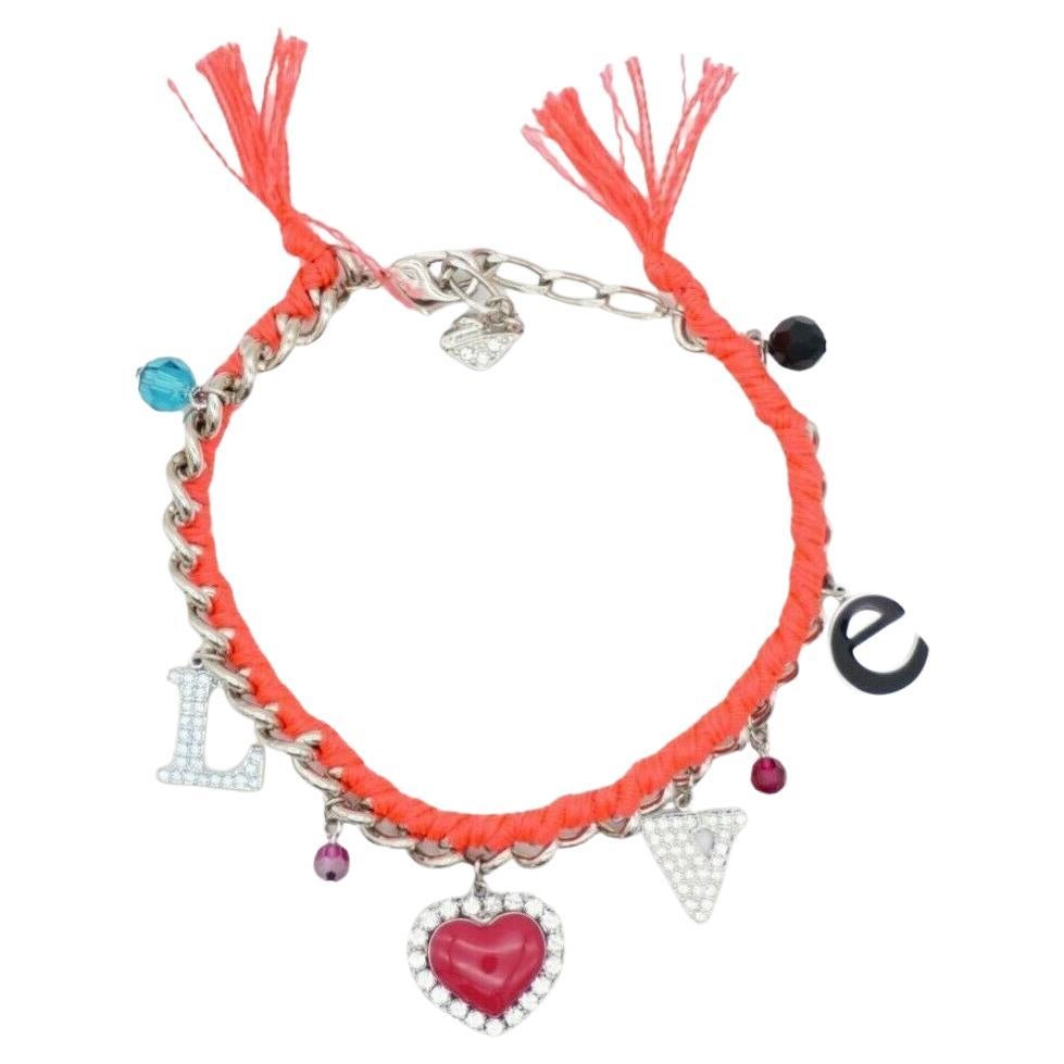 Swarovski Love Heart Charm Alphabet Shining Crystals Pink Red Bracelet Silver Tone

Decorated with eight charms – an “L” and “V” set with Austrian crystals, a red heart with an Austrian crystal border, a black enamel “e” and four coloured oval