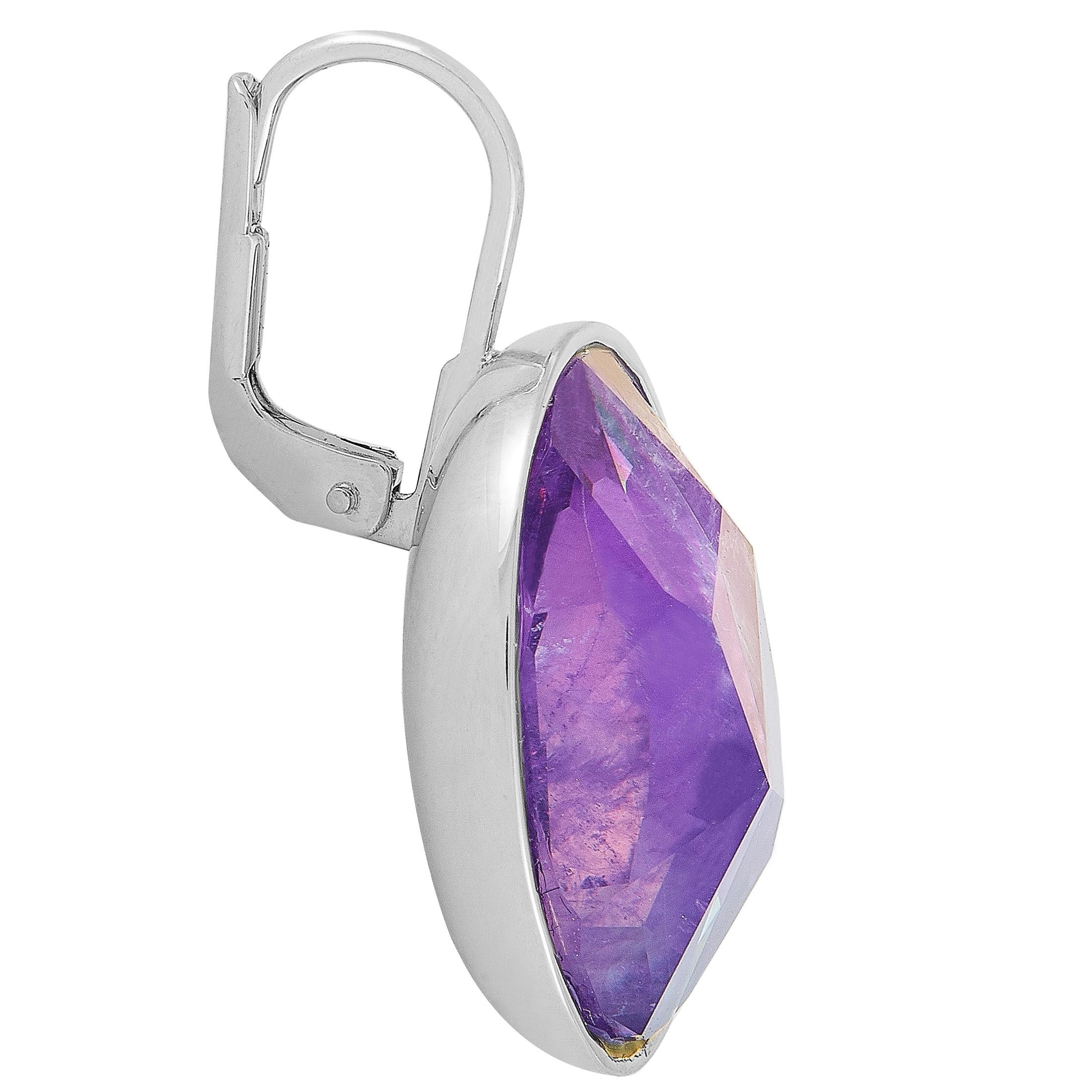 The Swarovski “Oval” earrings are crafted from rhodium-plated stainless steel and set with purple Swarovski crystals. The earrings measure 1.12” in length and 0.62” in width, and each of the two weighs 5.6 grams.