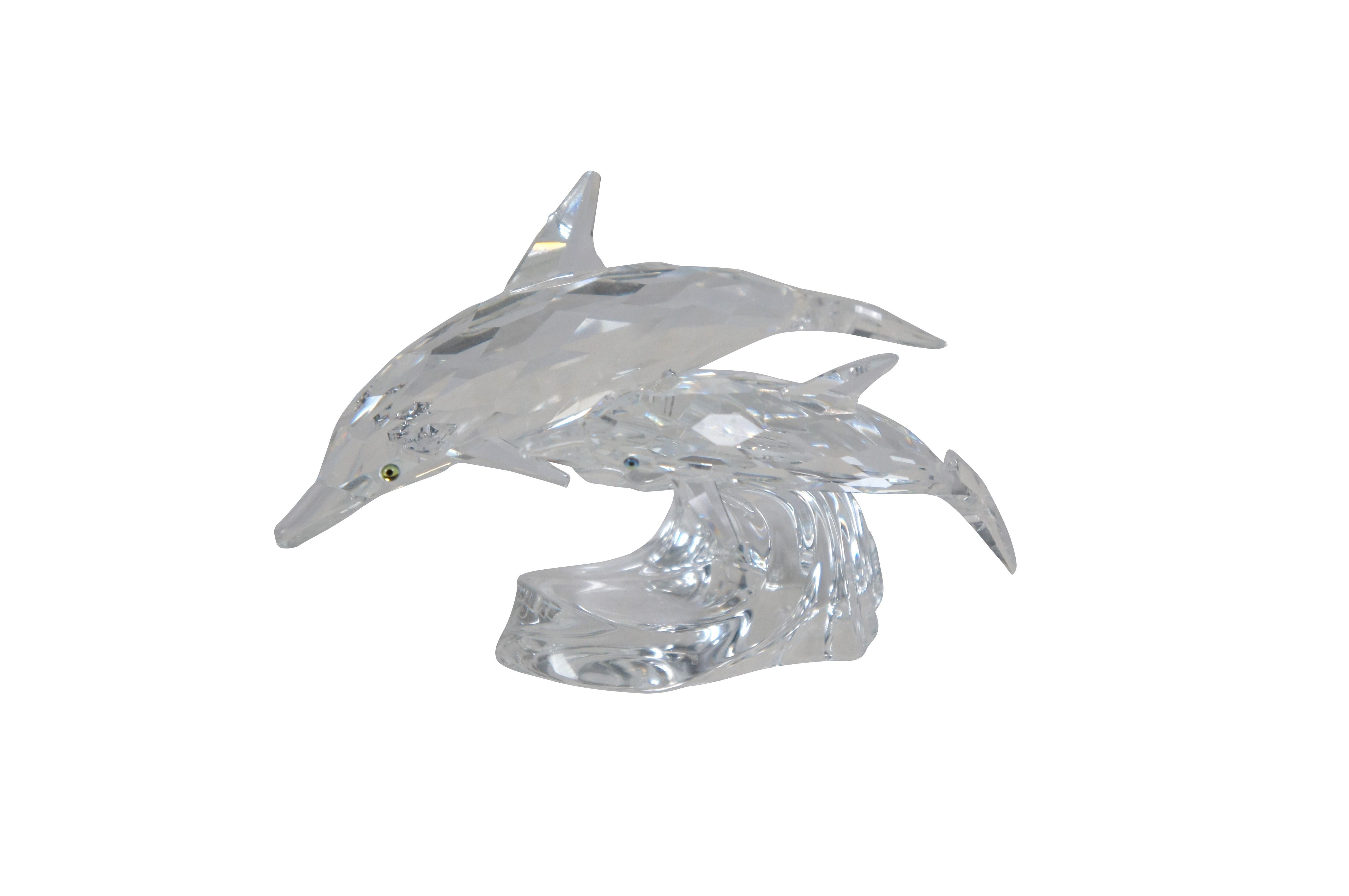 Swarovski Collectors Society Annual Edition 1990 - Lead Me - The Dolphins and 1991 - Save Me - Seals. Pair of clear crystal figurines with black eyes, depicting an adult / mother and baby dolphin on a wave and an adult / mother and baby seal / sea