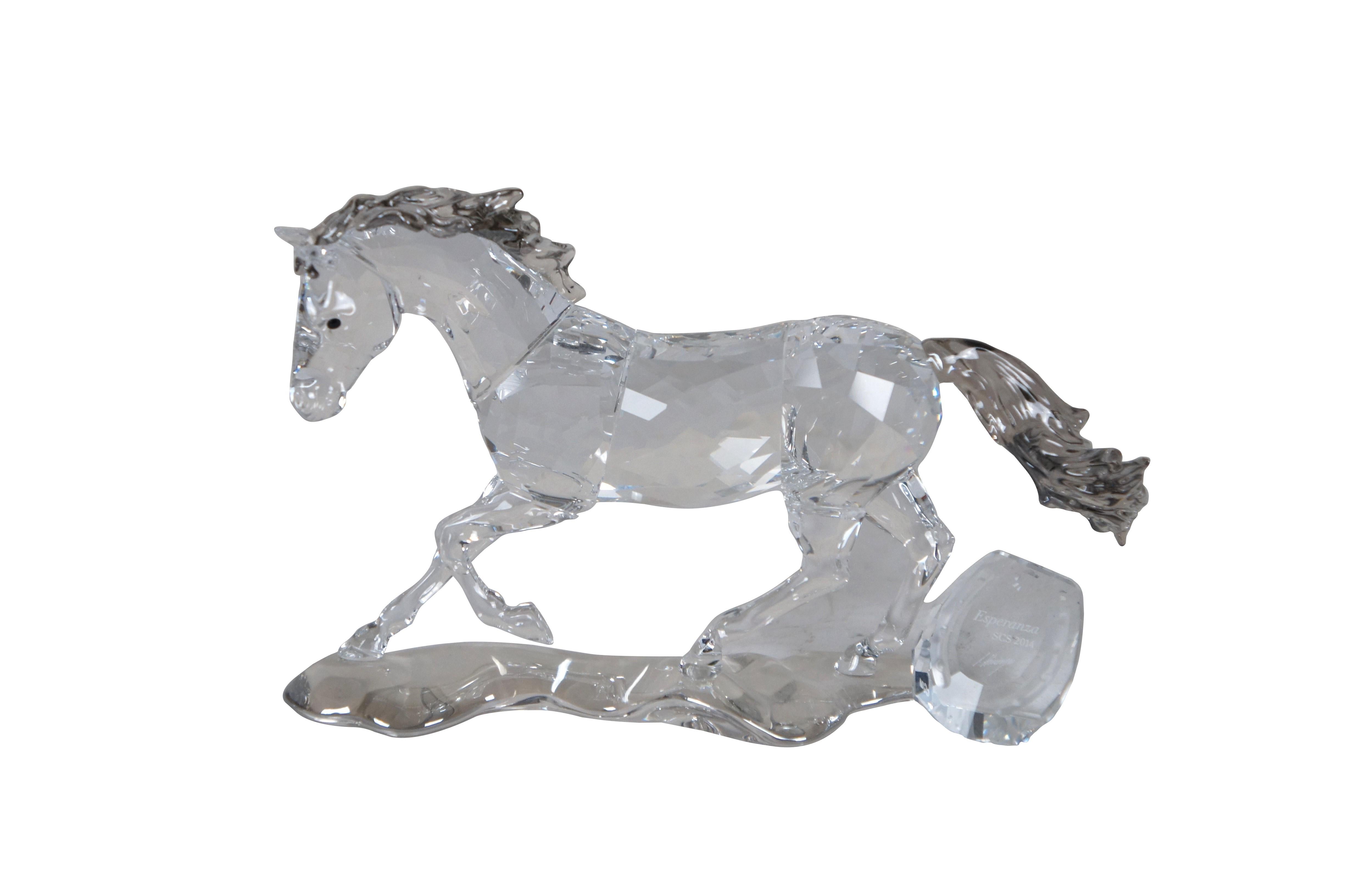 Swarovski Collectors Society 2014 Annual Edition, Esperanza Horse. Clear crystal figurine in the shape of a running horse with gray mane / tail and black eyes. Includes hoof print / horseshoe shaped plaque with signature of designer Anton Hirzinger.