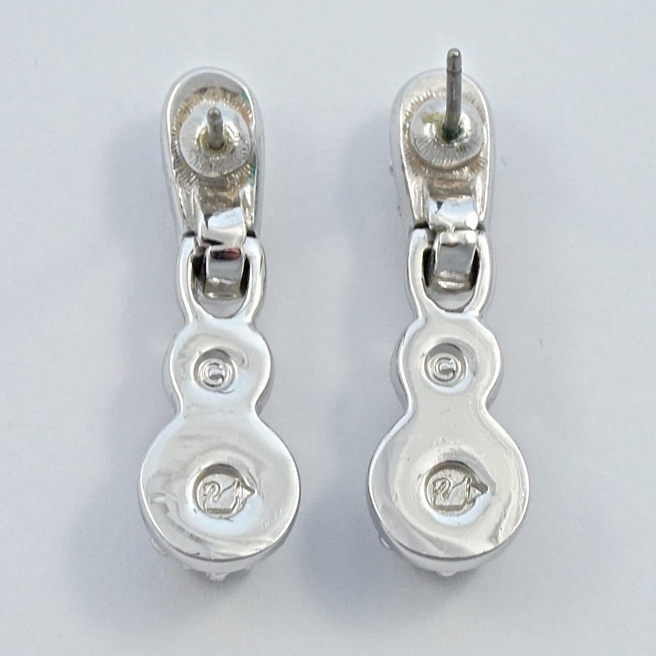 Swarovski lovely silver tone drop earrings set with clear faceted crystals. The earrings are stamped with the Swarovski swan logo. Length 3.3cm / 1.3 inches. The earrings are in very good condition, and will arrive in their original box.

These