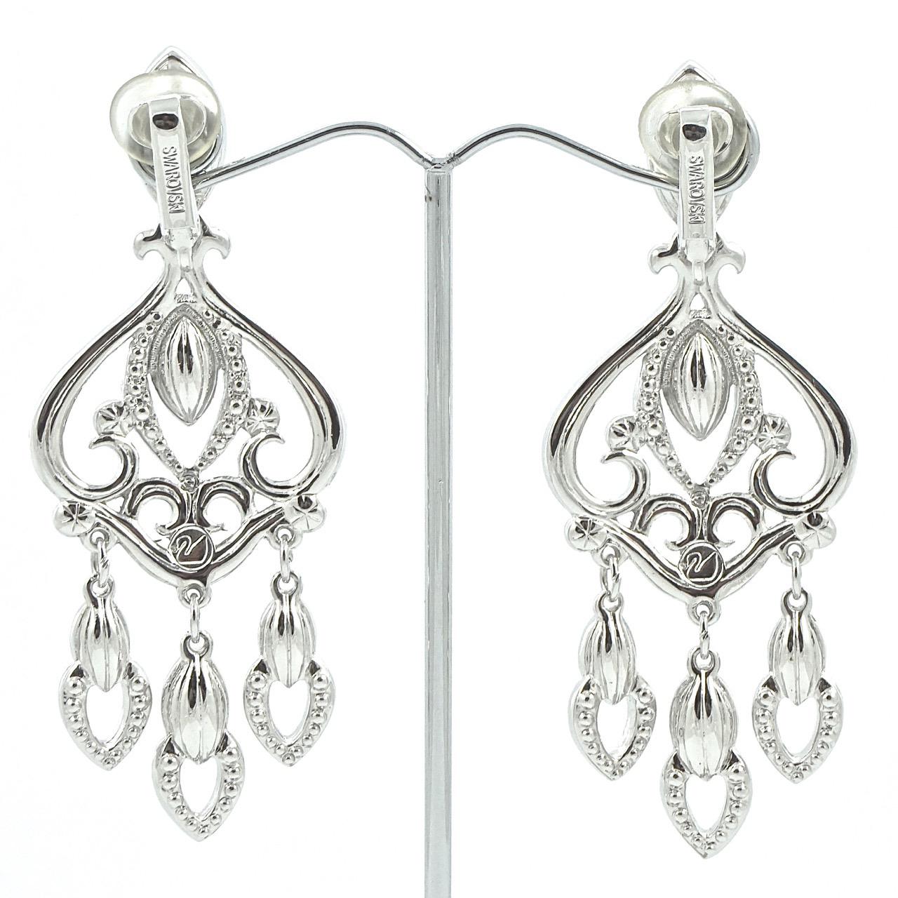 
Swarovski beautiful silver tone chandelier earrings set with clear faceted marquise and round crystals. The earrings are stamped with the Swarovski swan logo. Length 7.6cm / 3 inches by width 2.9cm / 1.14 inches. The earrings are in very good