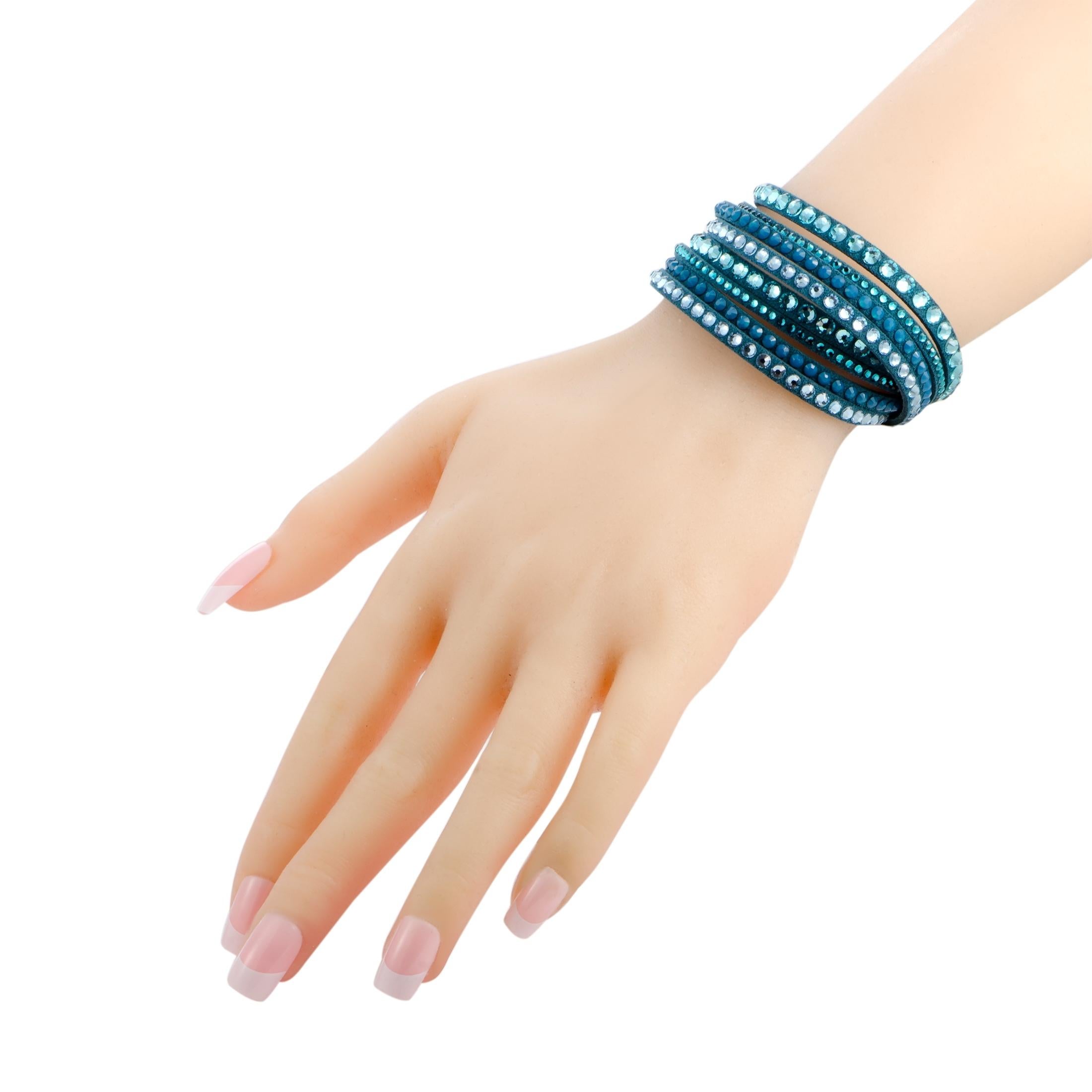 Add a stunningly fashionable twist to your outfits with this extraordinarily stylized bracelet that is presented in eye-catching blue and attractively decorated with a plethora of enticing crystals. The bracelet is a Swarovski piece and it weighs 10