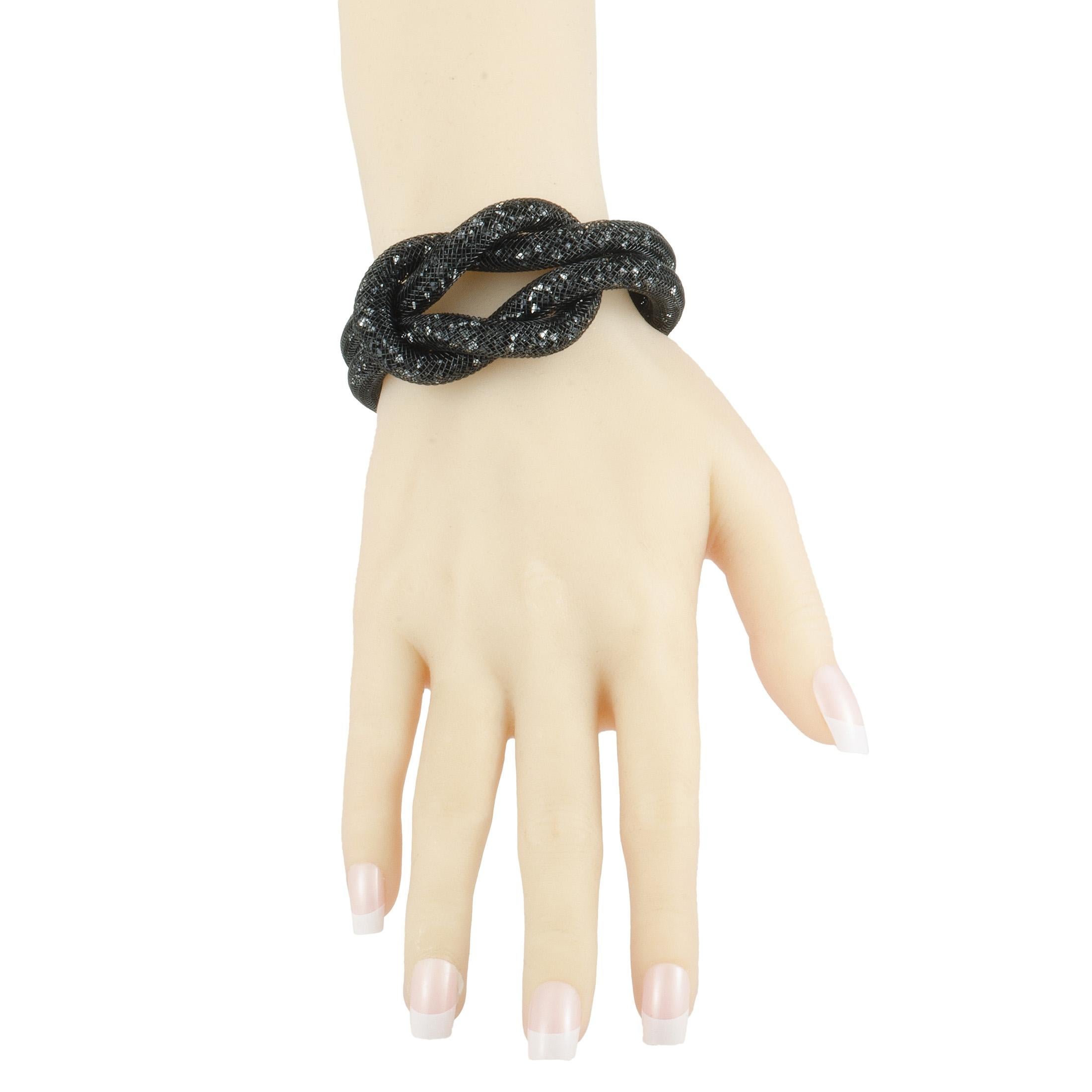 Add a fashionably edgy twist to your outfits with this captivating jewelry piece from Swarovski that boasts the stylish fishnet tube filled with numerous black crystals. The bracelet is designed for the imaginative Stardust collection and offers an