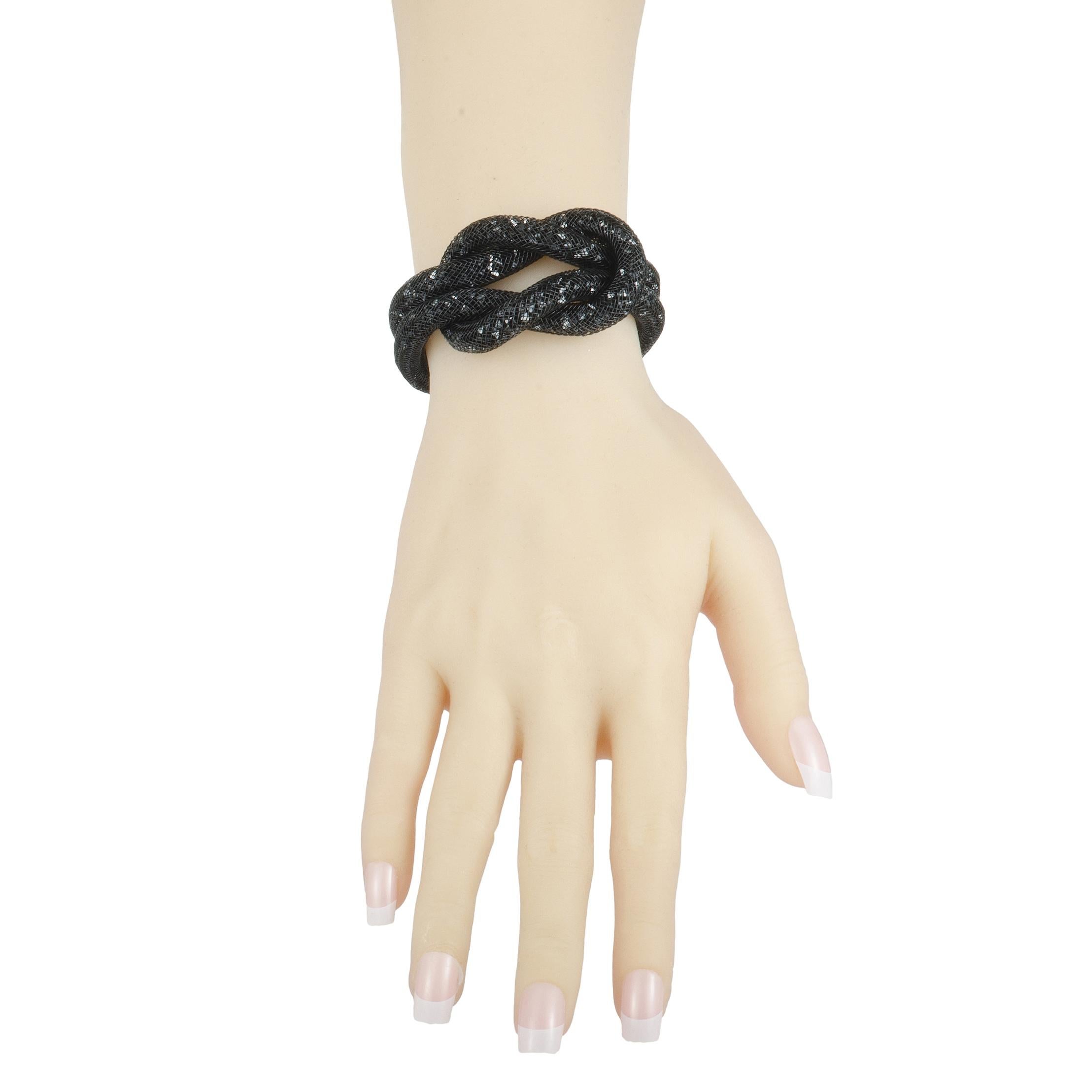 This extraordinarily envisioned jewelry piece is presented by Swarovski, created for the incredible Stardust collection. The bracelet offers a stunningly fashionable look, boasting intricate fishnet tube filled with a plethora of black crystals.