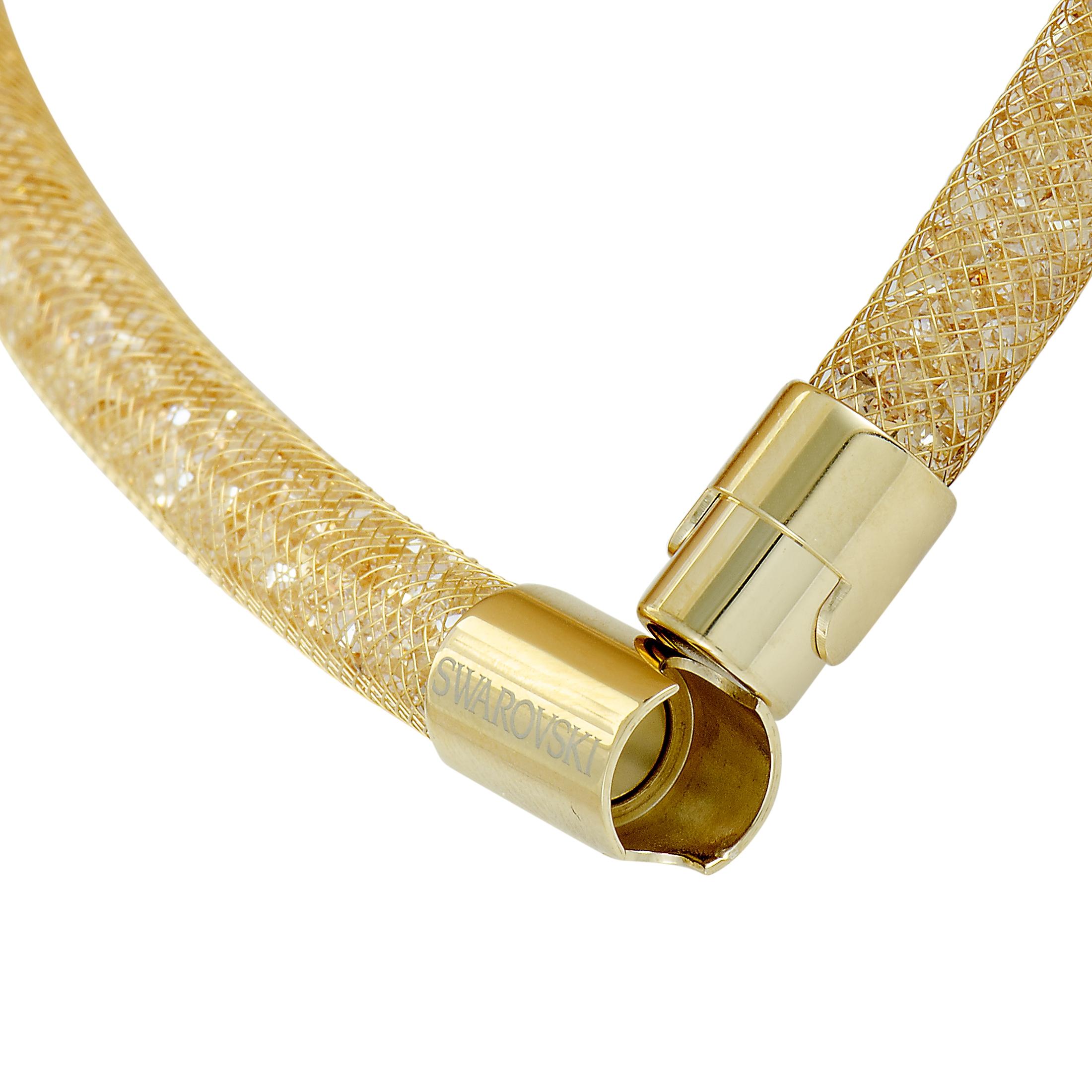 The Swarovski “Stardust” bracelet is presented with a gold-toned fishnet tube filled with a plethora of crystals and it weighs 32.5 grams, measuring 7.00” in length.
 
 This item is offered in brand new condition and includes the manufacturer’s