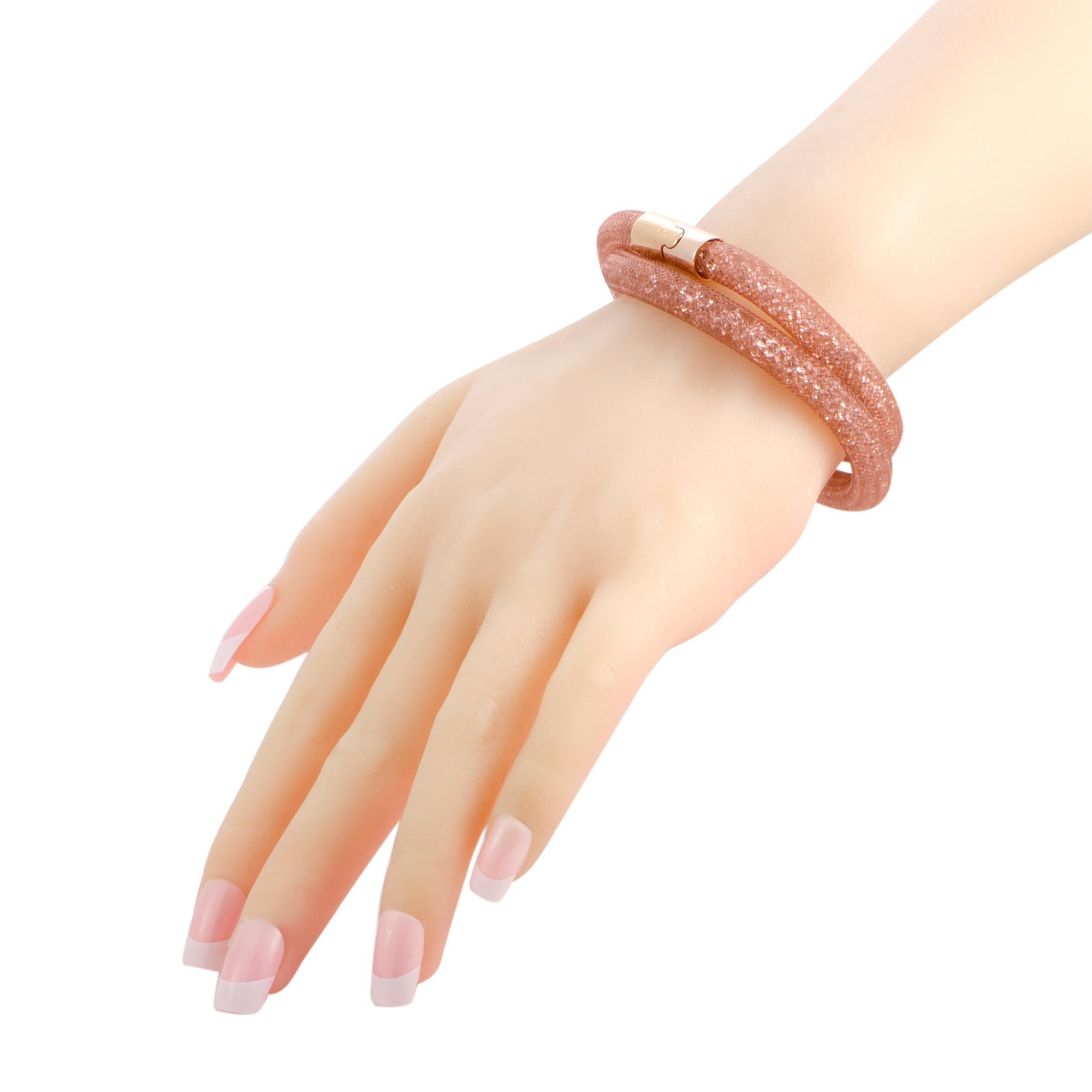 While the wonderfully resplendent, exquisitely cut, and charmingly alluring crystals produce splendid luster in the brand’s distinctive and highly renowned style, the exceptionally subtle fishnet tube adds delightful color to this marvelous bracelet