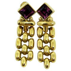 Orecchini a clip firmati Swarovski, placcati in oro e con cristalli di ametista, design anni 
80