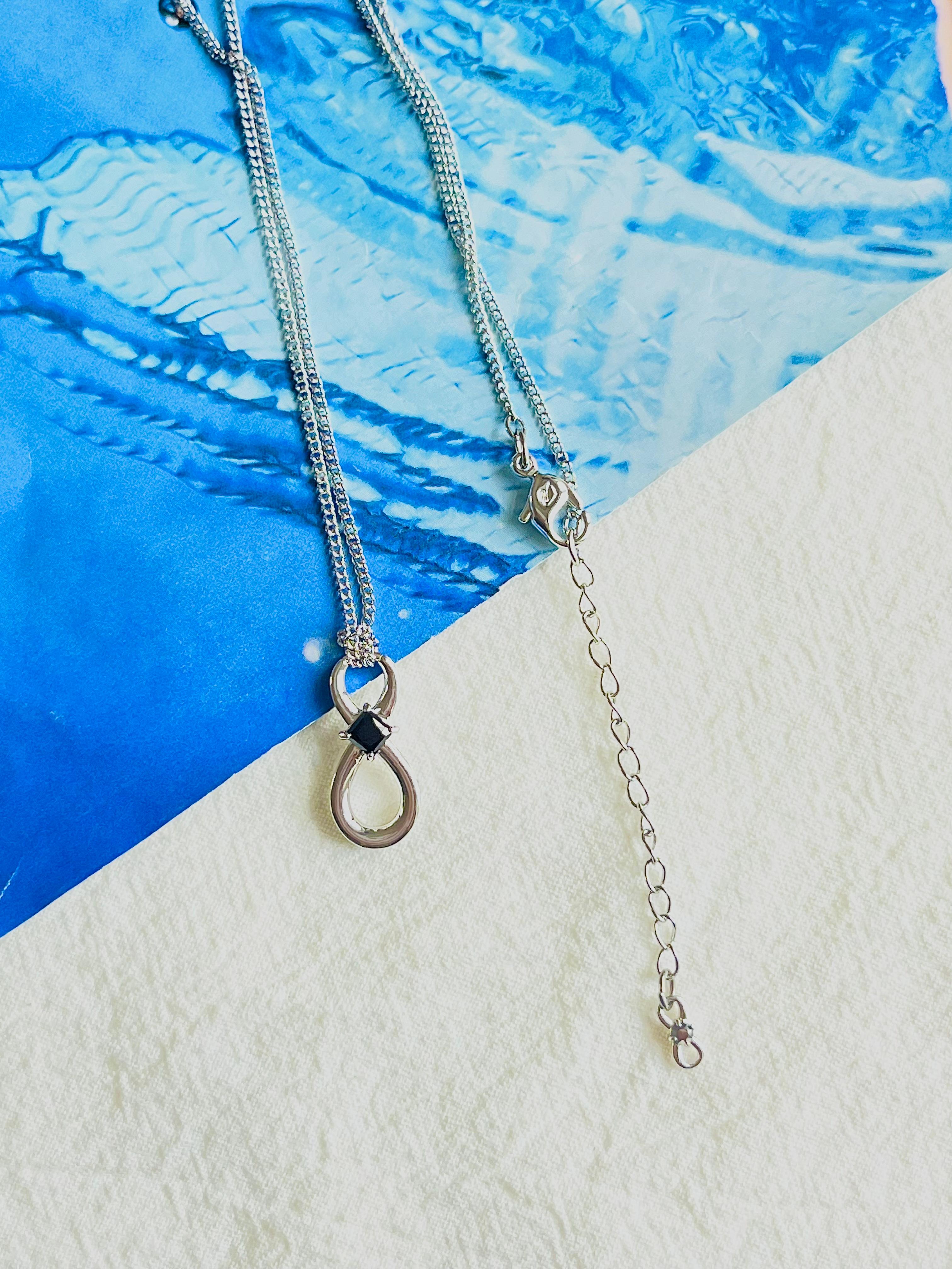 New with box. 100% Genuine.

This Swarovski pendant is truly timeless. It features the symbol of infinity with a single, dark stone set at the symbol's junction that contrasts attractively with its rhodium plating. The design's simple elegance makes