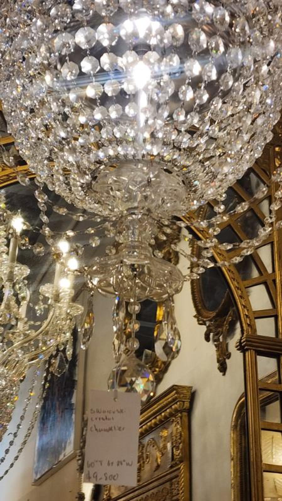 This listing features a gorgeous Swarvoski basket chandelier, that would brighten any room.