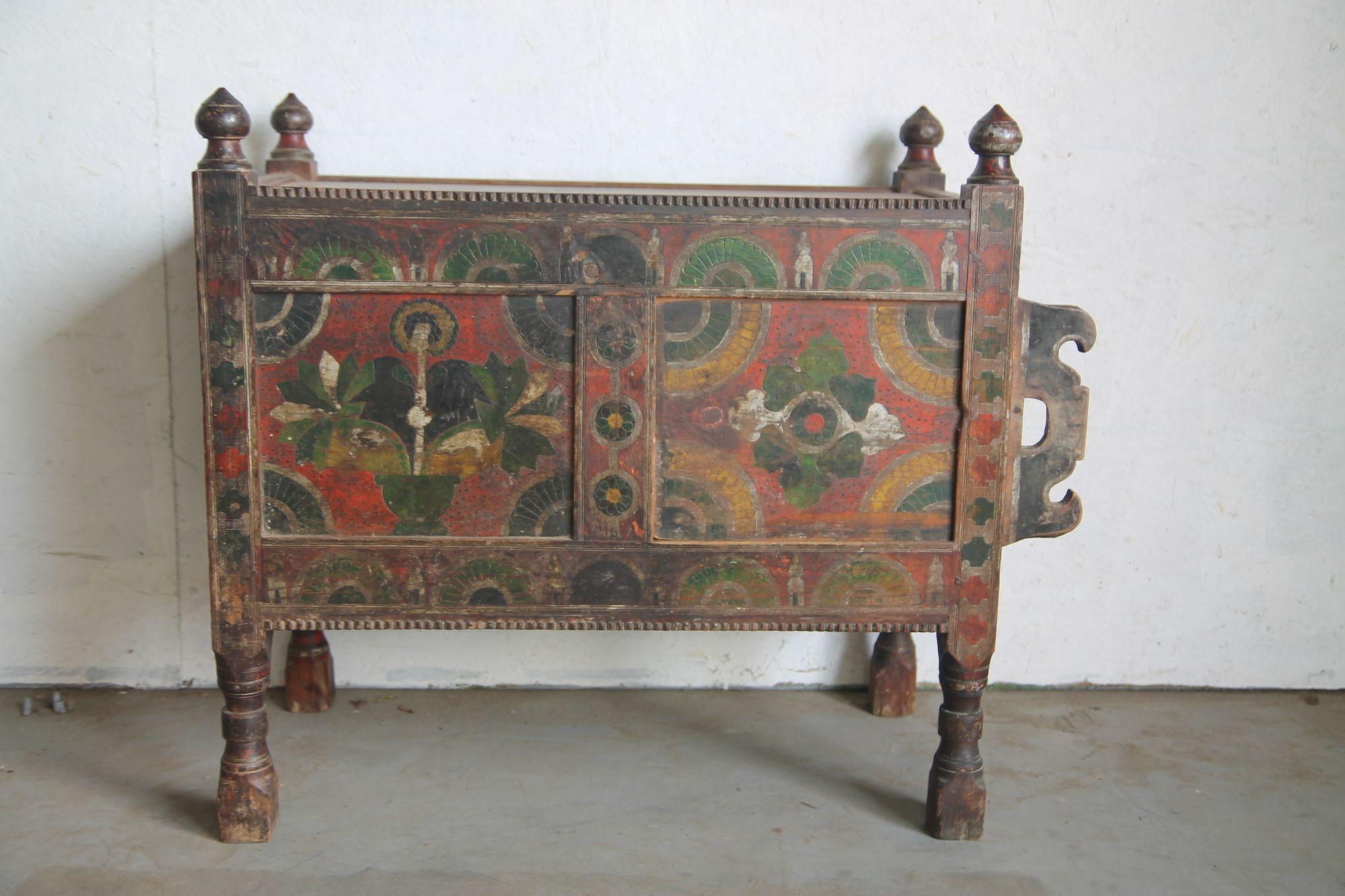 Wonderful hand painted swat valley chest.  The colors are great on this piece.  There is a sliding door that allows access into this chest.