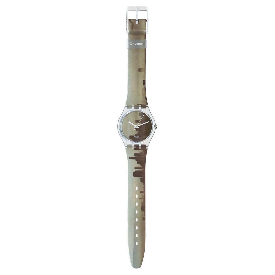 Introducing the Swatch Gent OXYGEN, a gem from the coveted 1997 elements series. This exquisite timepiece is a celebration of air, portrayed through a vibrant skyline in mesmerizing yellow tones adorning its entire surface. The watch features a