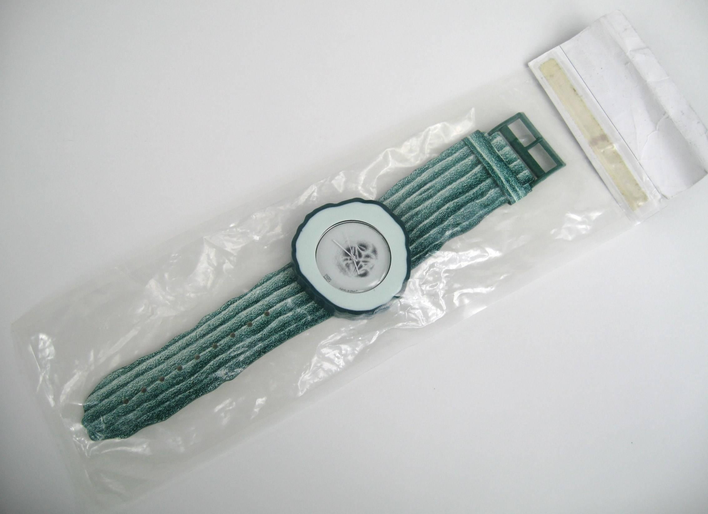 1991 Guhrke Artist Series Swatch Uhr #334/9999. Nie getragen oder aus der Verpackung genommen. Gu(h)rke (PWZ100) ist ein kühles Grün, bis hin zum Zifferblatt, das wie eine feuchte, entkernte Gurkenscheibe eingefärbt ist. Die Uhr befindet sich noch