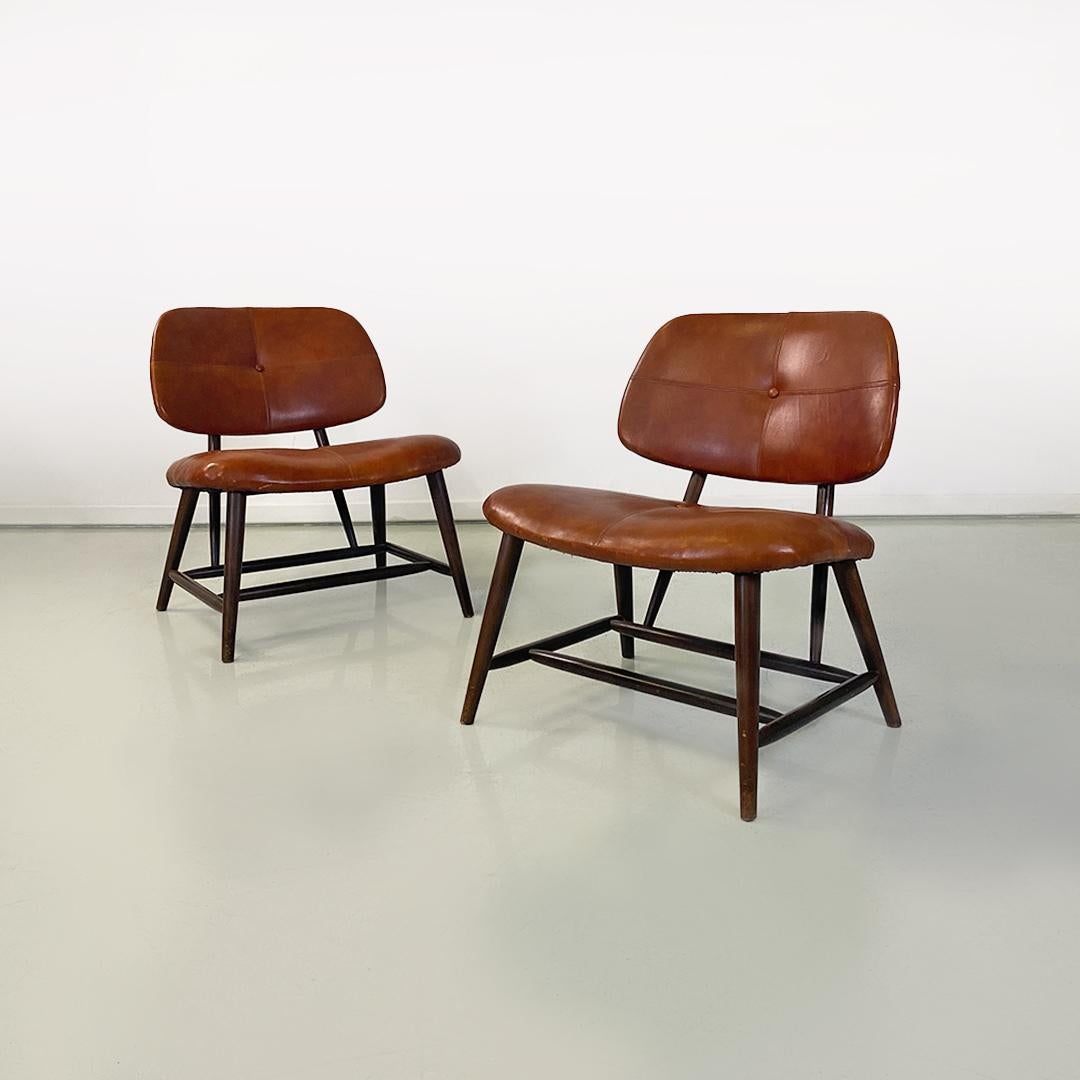 Sweden mid century modern pair of wood and brown leather Teve armchairs by Alf Svensson for Ljungs Industrier AB, 1953.
Pair of Teve model armchairs with round section shaped wooden structure, with padded seat and back covered in brown leather with