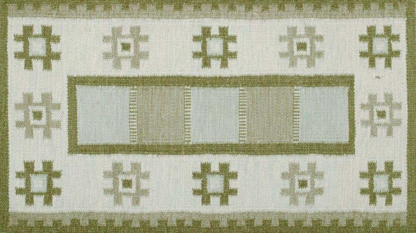 Swedish textile artist. Handwoven wool carpet in Rölakan technique. 
Modernist design. Green colors on a white background.
Approximately 1970.
Perfect condition.
Dimensions: 136 cm x 65 cm with fringes.