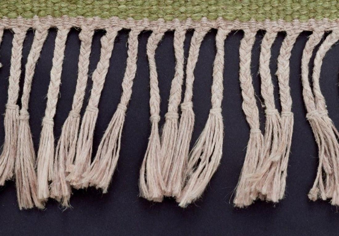 Laine Tapis en laine de Suède selon la technique Rölakan. Couleurs vertes sur fond blanc. en vente