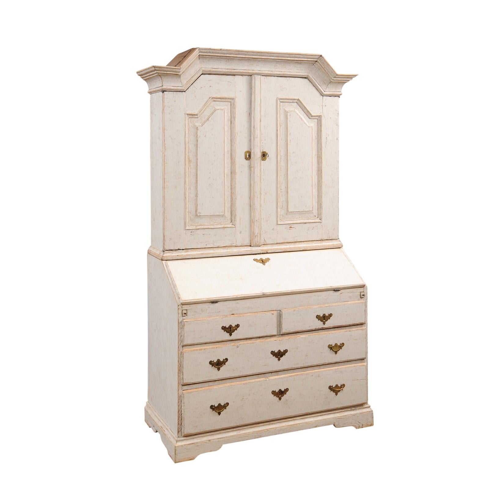 A Swedish Baroque tall secretary from circa 1770, with slant front desk, light Gustavian gray painted finish, two doors and four drawers. Experience the timeless elegance of this Swedish tall secretary from circa 1770, a piece that seamlessly