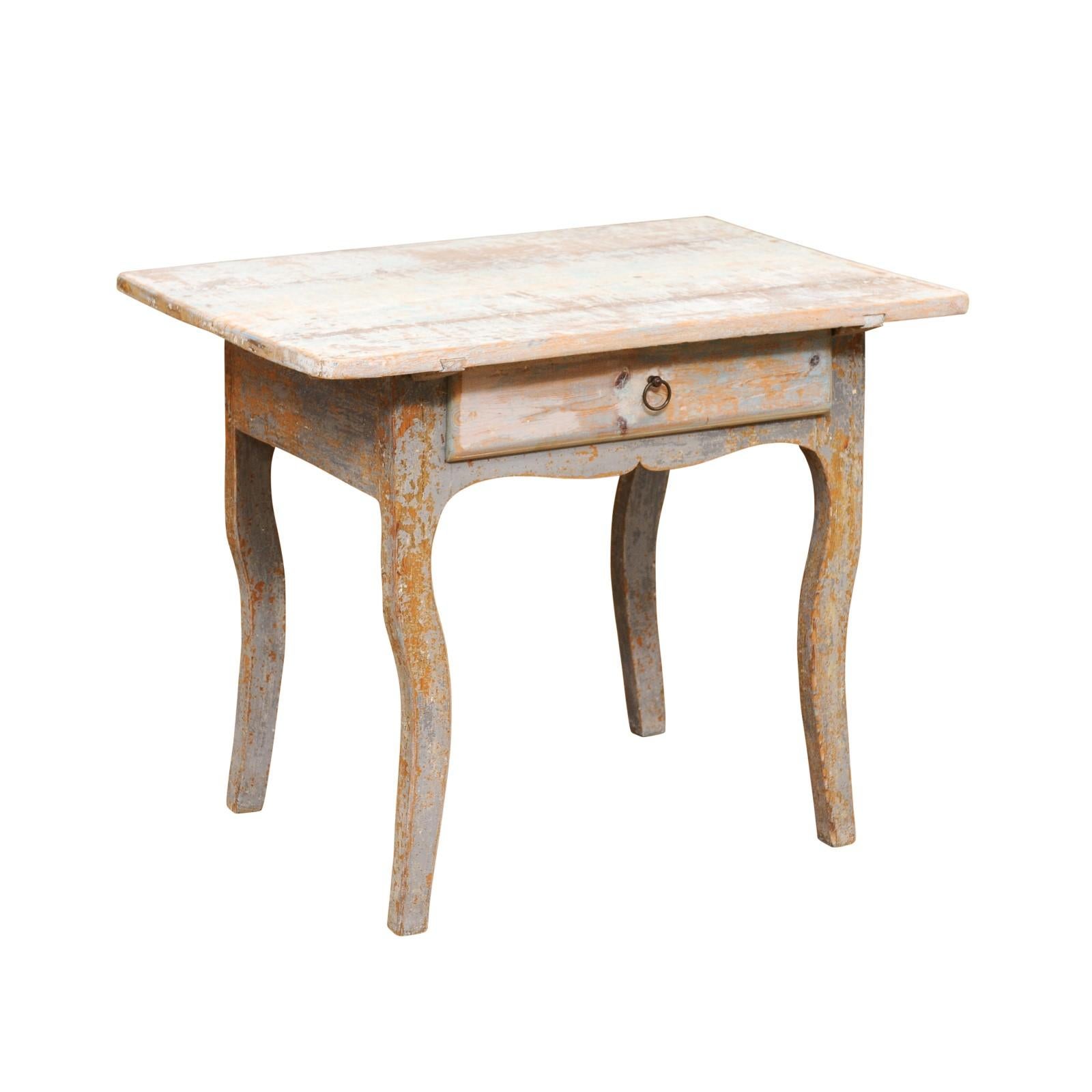 A Swedish Folk Art side table from the late 18th century, with Rococo style legs and distressed patina. Created in Sweden during the last decade of the 18th century, this wooden side table features a rectangular top sitting above a simple apron with