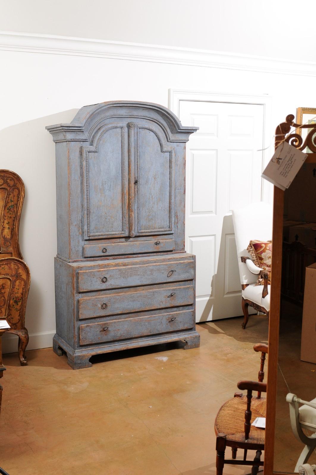 A Swedish Provincial cabinet from the late 18th century, with bonnet top, doors, drawers and nicely weathered patina. Created in Sweden during the last decade of the 18th century, this painted cabinet draws our attention with its bonnet top sitting