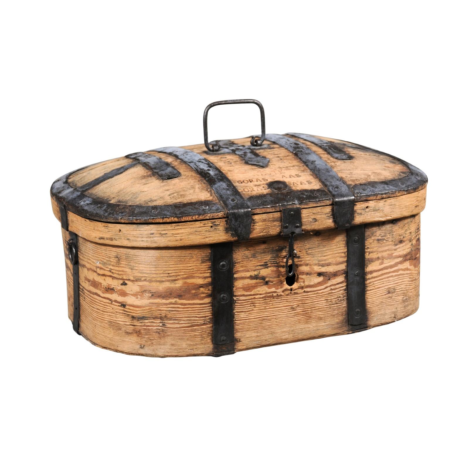 A rustic Swedish wooden box from the late 18th century, with iron accents and natural patina. Created in Sweden during the last decade of the 18th century, this wooden box charms us with its rustic appeal and distressed appearance. Showcasing an