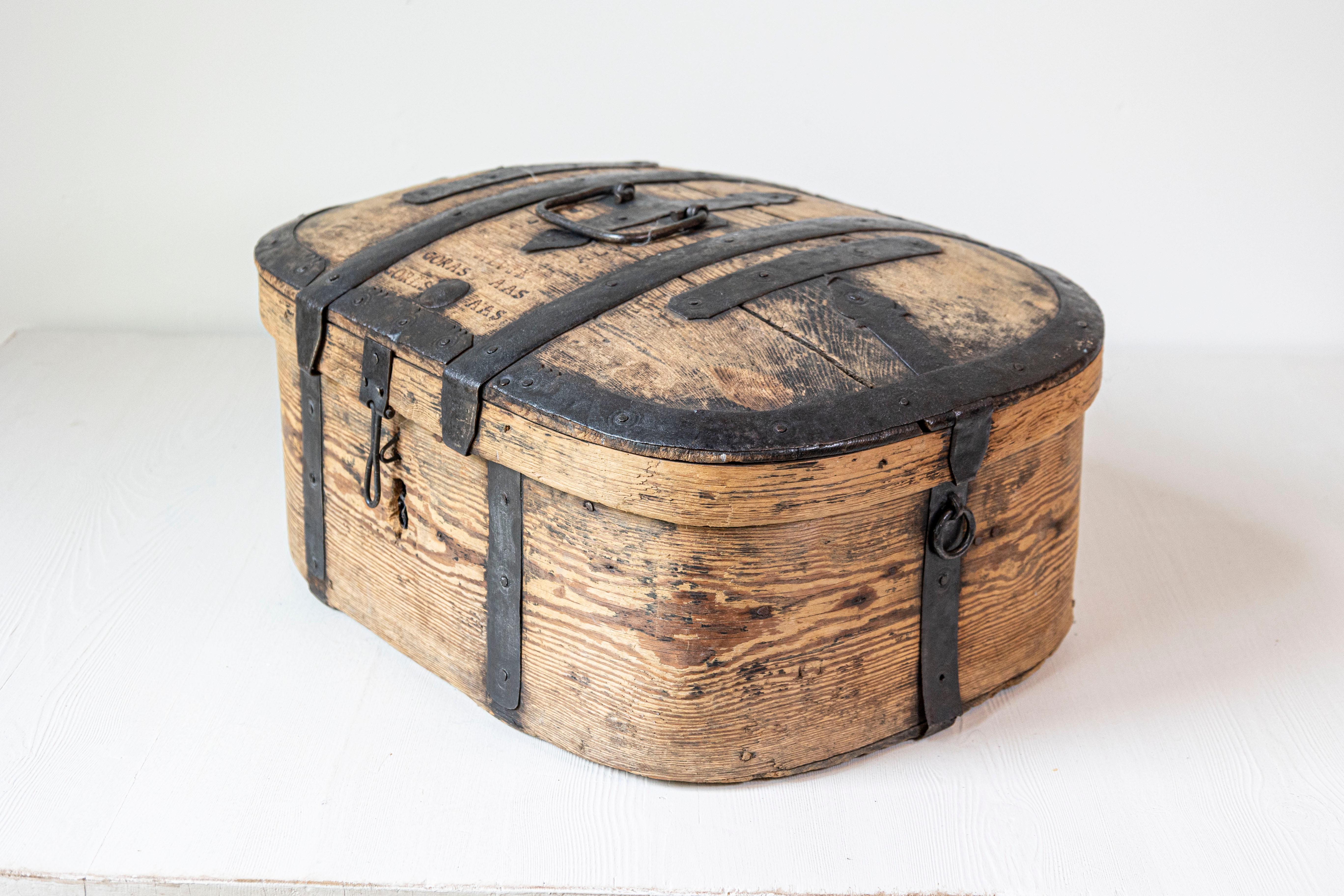 A rustic Swedish wooden box from the late 18th century, with iron accents and natural patina. Created in Sweden during the last decade of the 18th century, this wooden box charms us with its rustic appeal and distressed appearance. Showcasing an