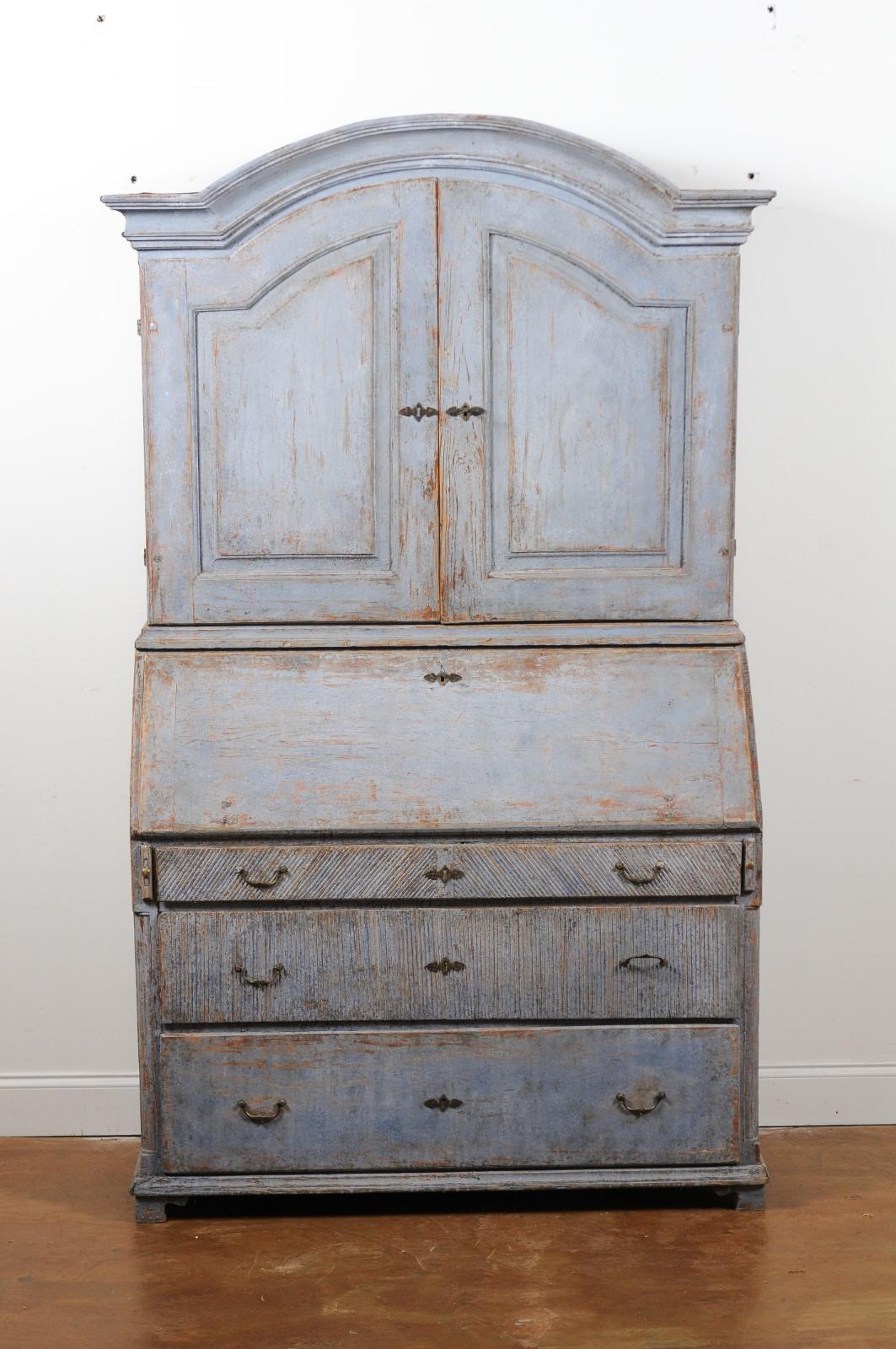 A Swedish late Gustavian two-part painted secretaire from the early 19th century, with bonnet top, slant front desk and chest of drawers. Created in Sweden during the early years of the 19th century, this tall painted secretaire features a