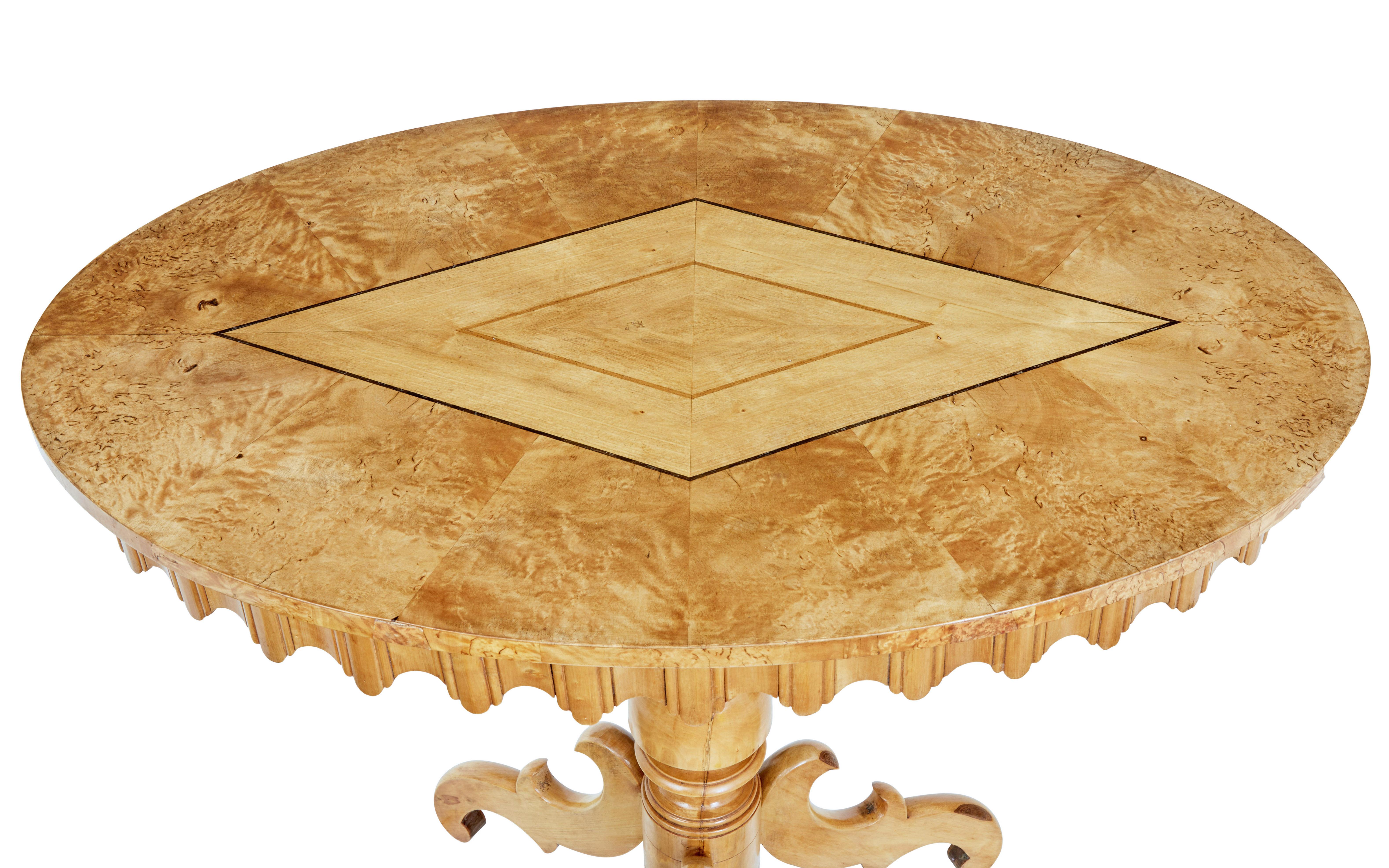 A Swedish birch inlaid occasional pedestal table from circa 1860 with oval top, radiating veneer, inlaid diamond motif, turned pedestal and carved tripod base. A Swedish birch inlaid occasional pedestal table from circa 1860, exuding classical