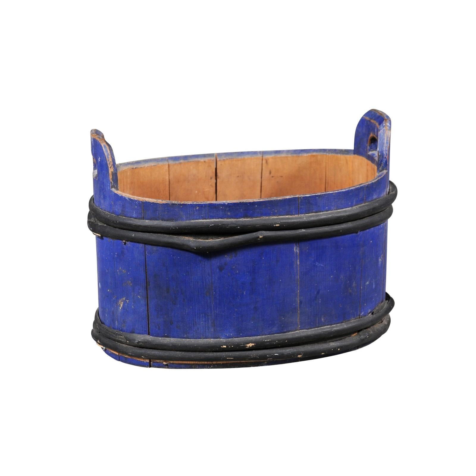 A Swedish oval-shaped milk tub from the late 19th century with blue paint and black accents. Created in Sweden during the last quarter of the 19th century, this milk tub attracts our attention with its rustic character and distressed blue paint.
