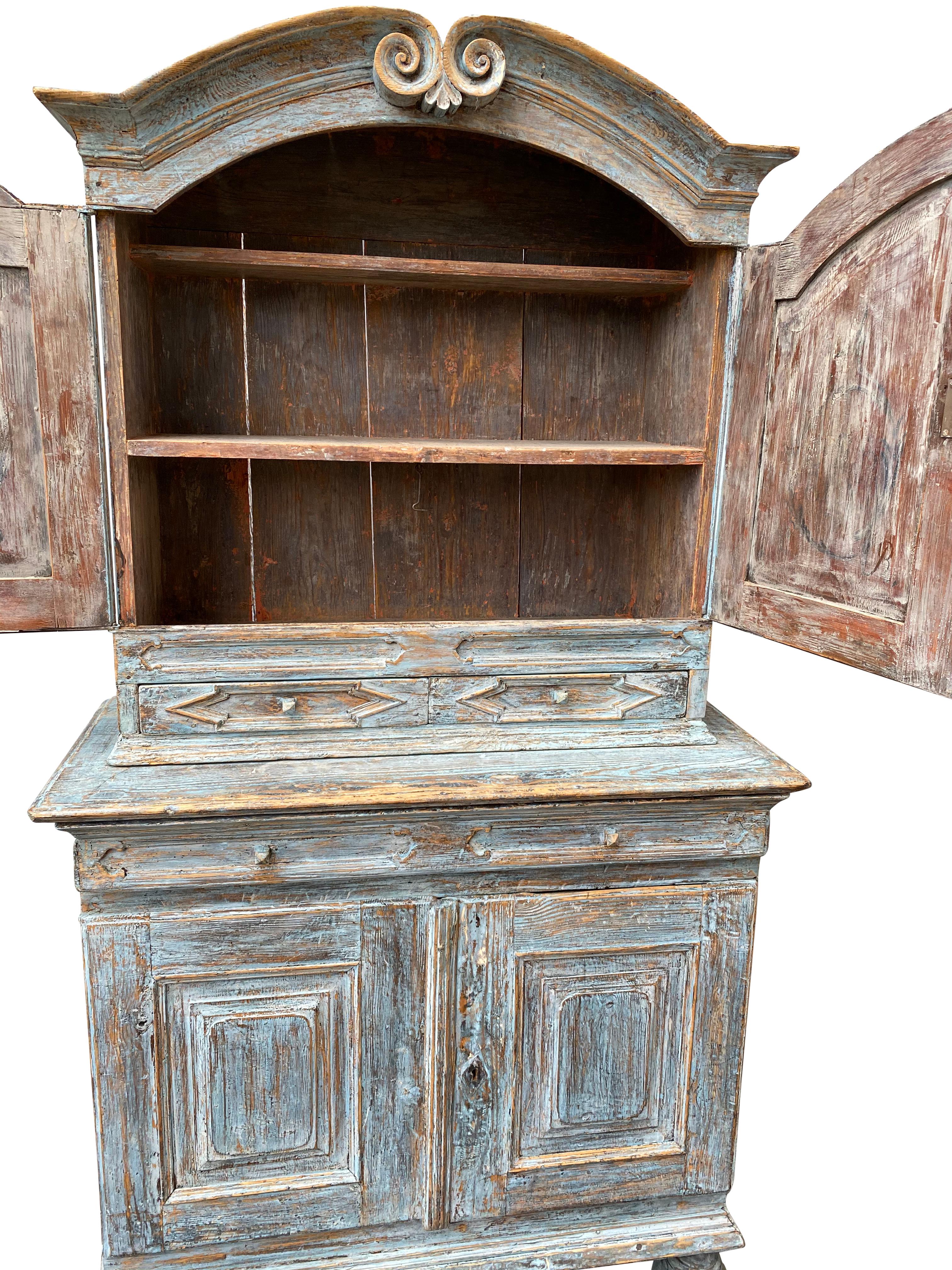 Swedish blue painted rococo cabinet, circa 1760

The cabinet has two shelves in each of the upper and lower sections.
The paint is partly original and partly retouched.
  