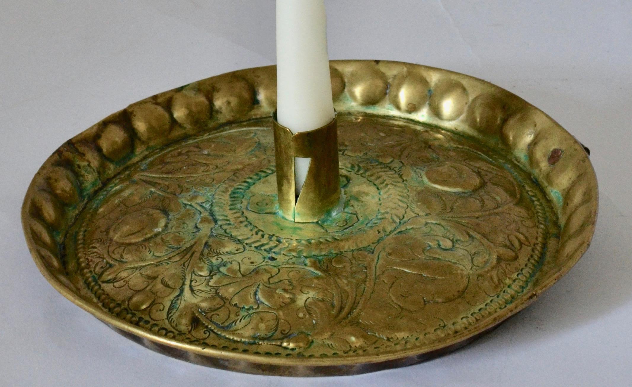 A Swedish 18th century brass candlestick with floral decoration.