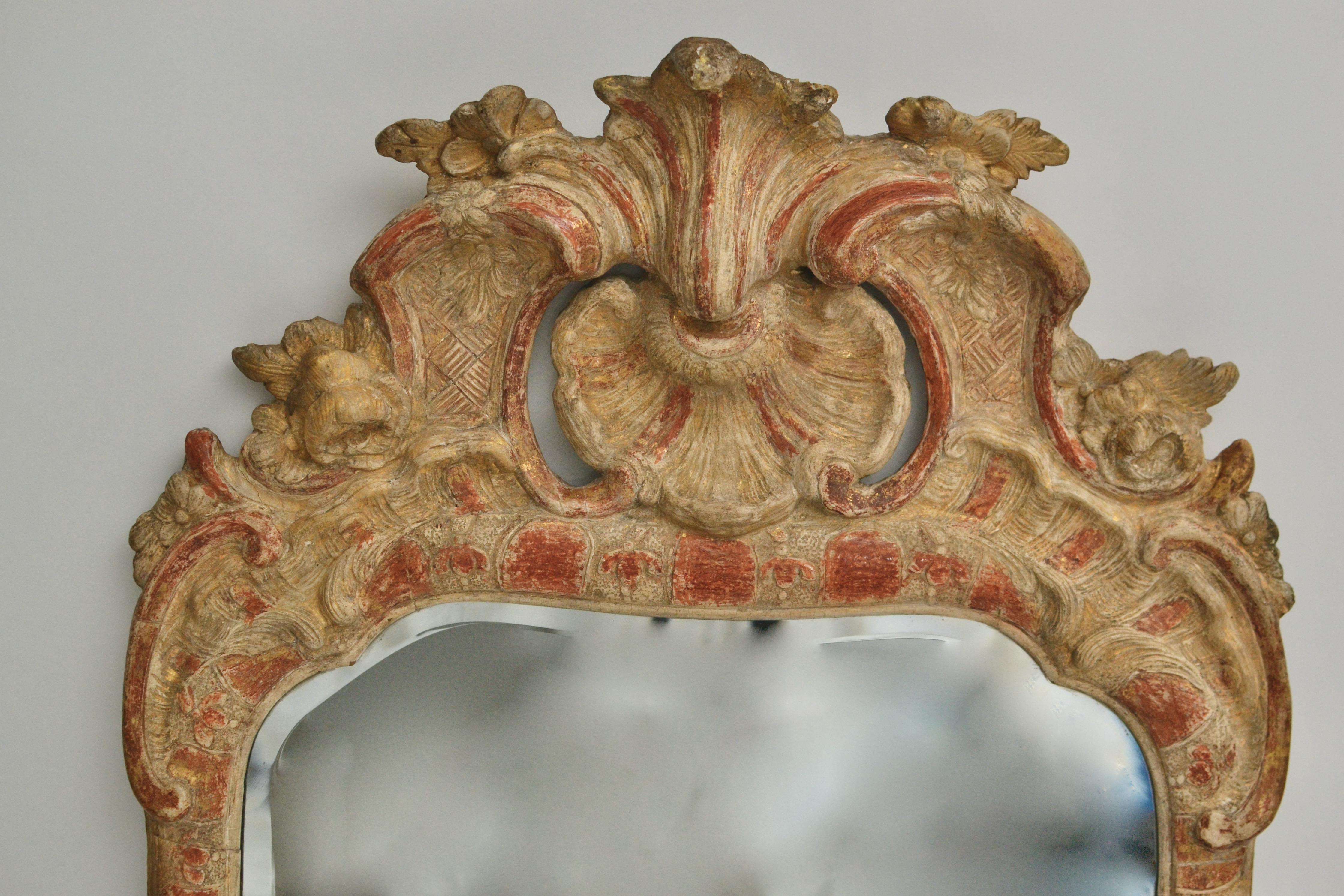 A Swedish 18th century gilt wood mirror made circa 1760 in Stockholm. The gilding is heavily worn and now there is a beautiful patina surface. 

 