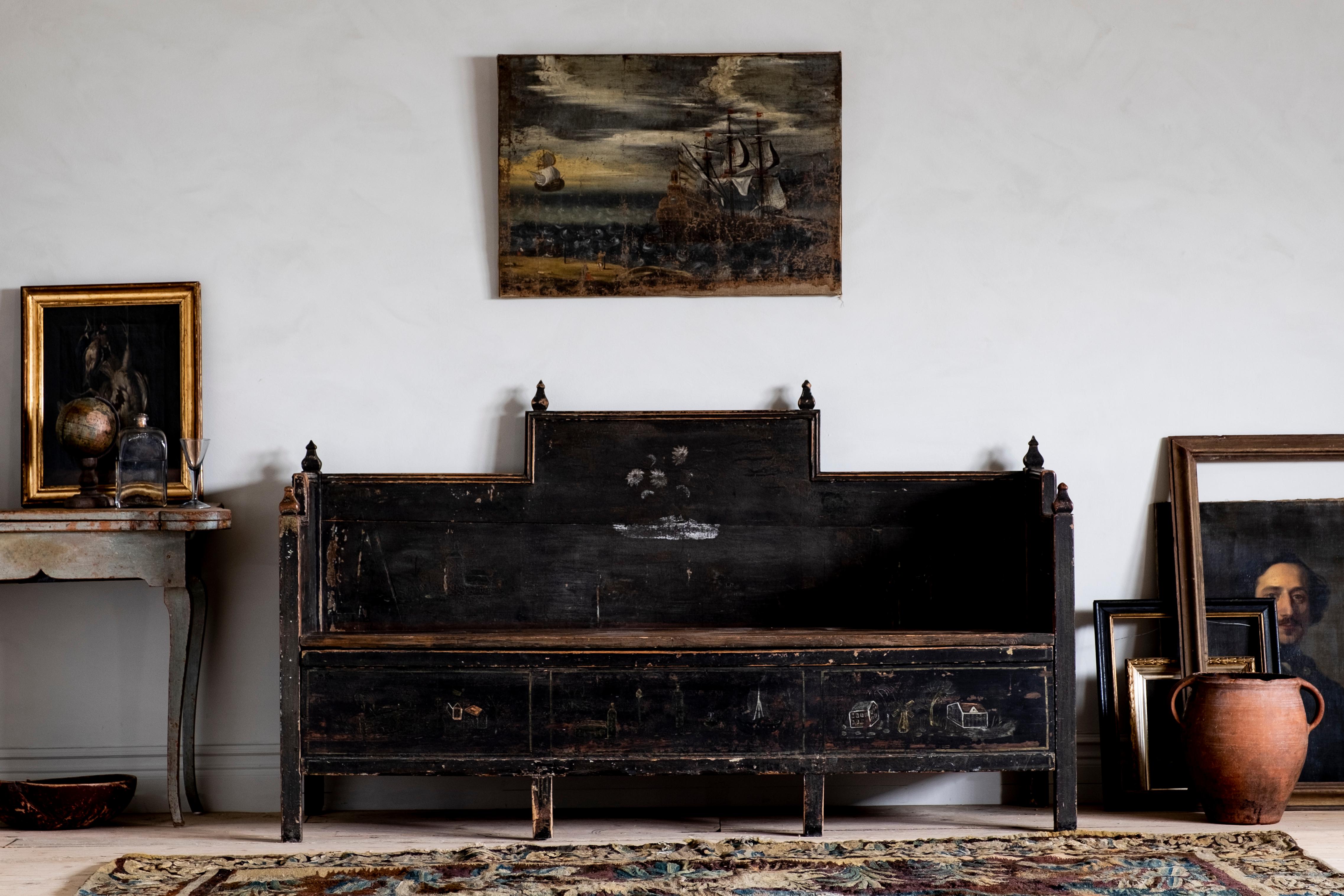 Most unusual 18th century Gustavian Folk Art sofa in its original black color with a good patinated surface. Wonderful naive paintings on the front and sides and the lid open for storage underneath, circa 1790 Sweden. 

The condition is good with