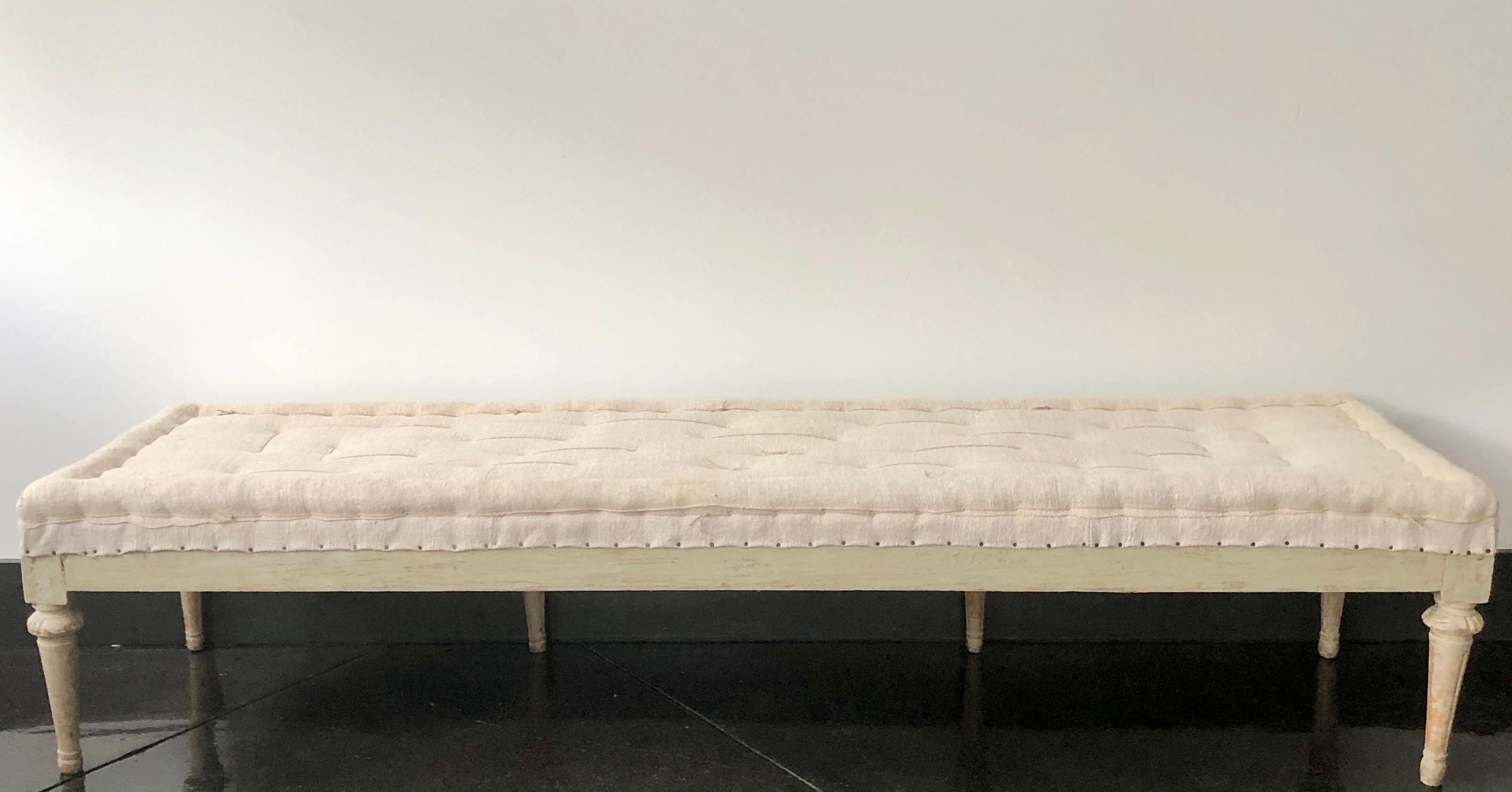 Very rare. Swedish 18th century Gustavian period bench, circa 1790, finished on three sides with Guilloché carvings on carved round fluted legs. Scraped to original cream /white finish and upholstered in traditional way in antique handstitched