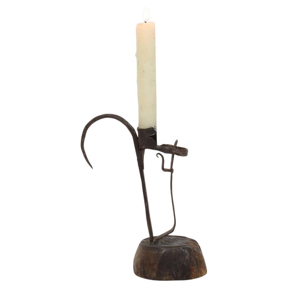 Wonderful folk art hand forged iron candleholder on a wooden base.
Beautiful simple design. Sweden circa 1750. weathered.
H:18,5cm  W:15cm D:8cm 