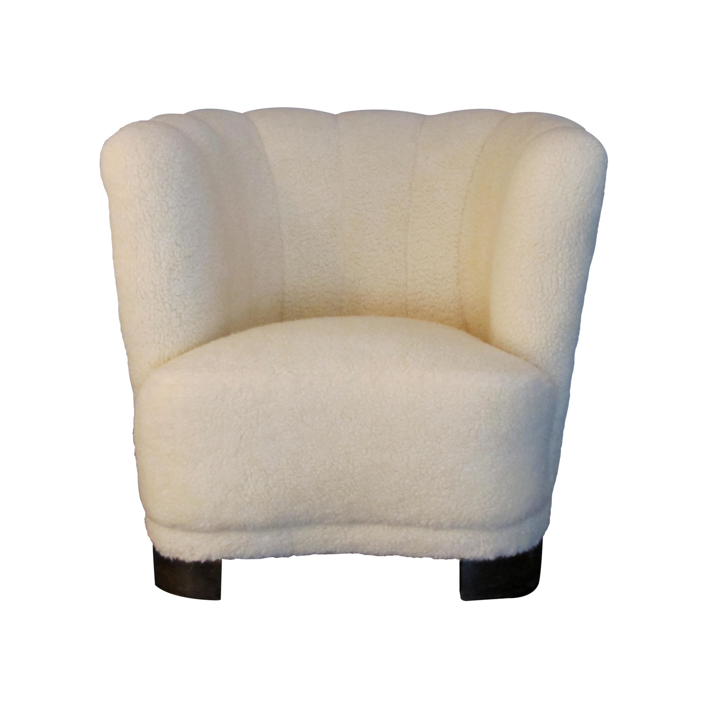 A stylish 1930s Swedish Art Deco club armchair reupholstered in a lambskin fabric mix fabric which is very soft with a luxurious feel to it. This deep-seated armchair is well-padded for extra comfort and will be a wonderful addition to most rooms of