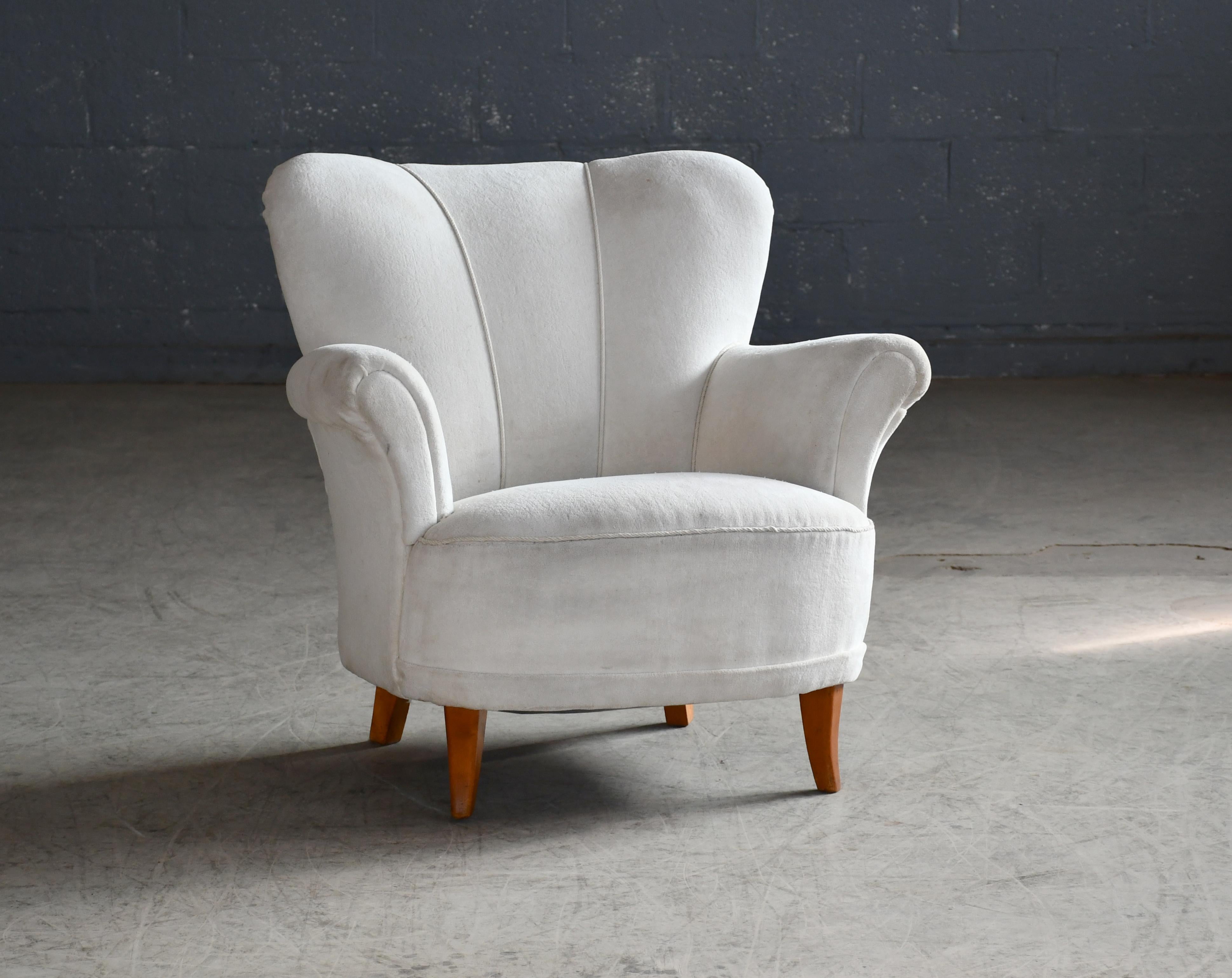 Beautiful 1940 or early 50's Swedish easy chair. Swedish chair have a distinct slightly more whimsical playful style than Danish chairs that are a bit more minimalist. The Swedish also liked to make the legs in lighter colors as opposed to the dark