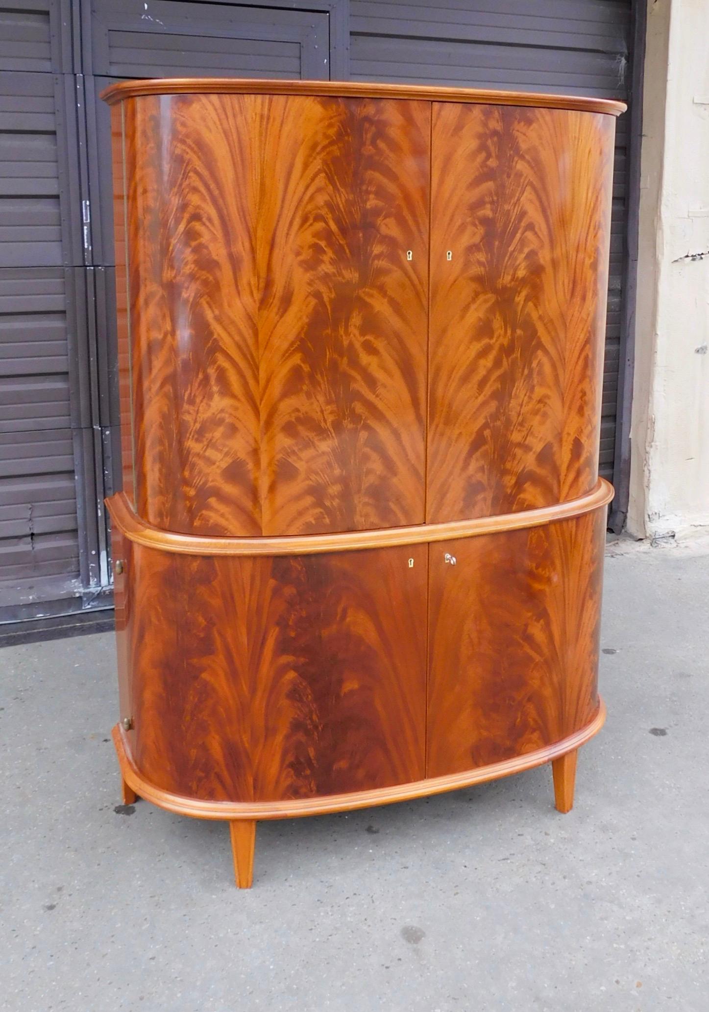 Swedish Art Moderne storage cabinet rendered in highly figured, book matched mahogany.
Interior composed of mahogany and birch woods. In beautiful original condition with some light restoration. Please see detailed photos. With all original