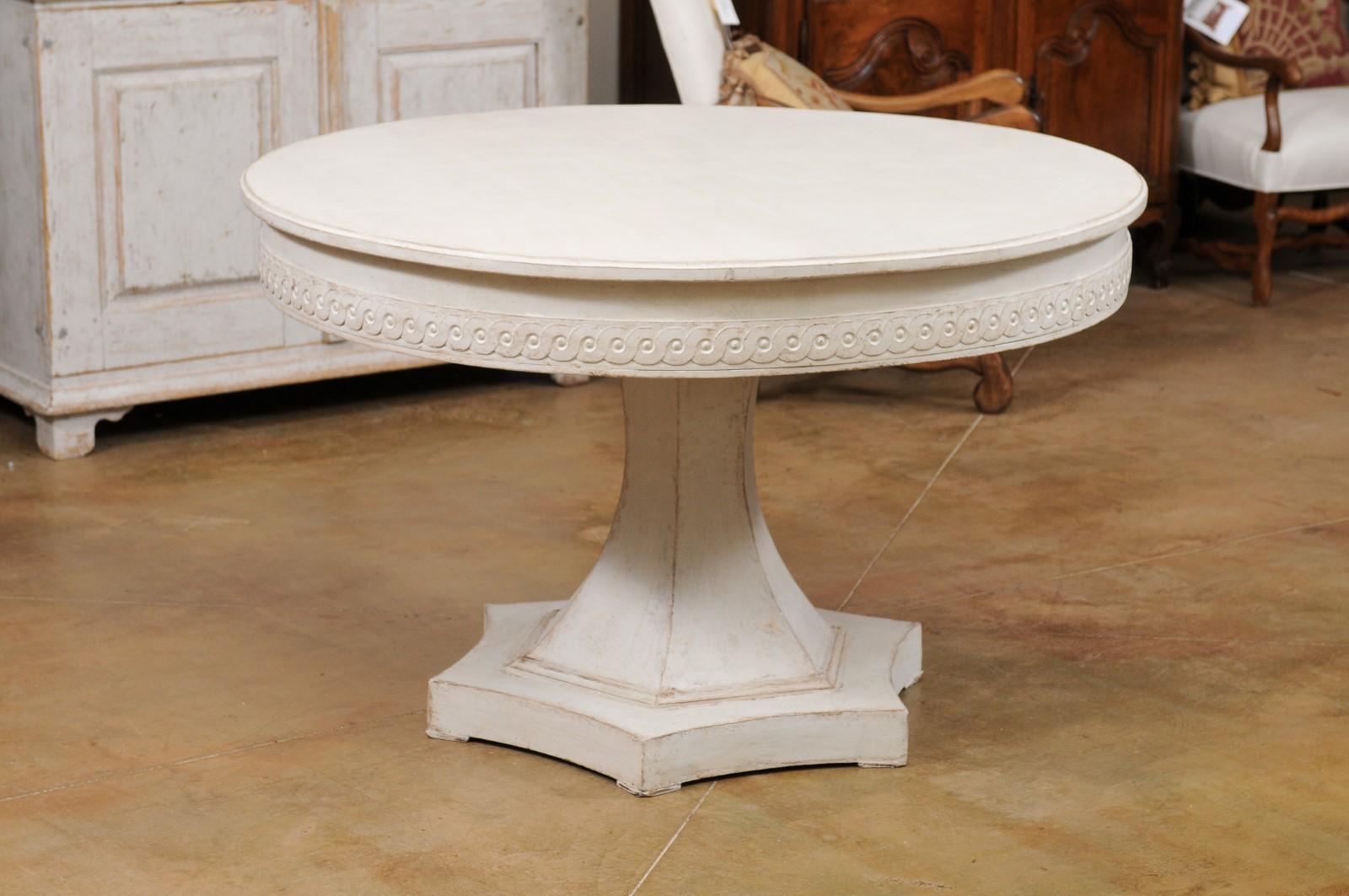A Swedish Neoclassical style pedestal table from the mid 19th century, with guilloche motifs and hexagonal base. Created in Sweden during the second quarter of the 19th century, this table features a circular top sitting above an apron carved with a
