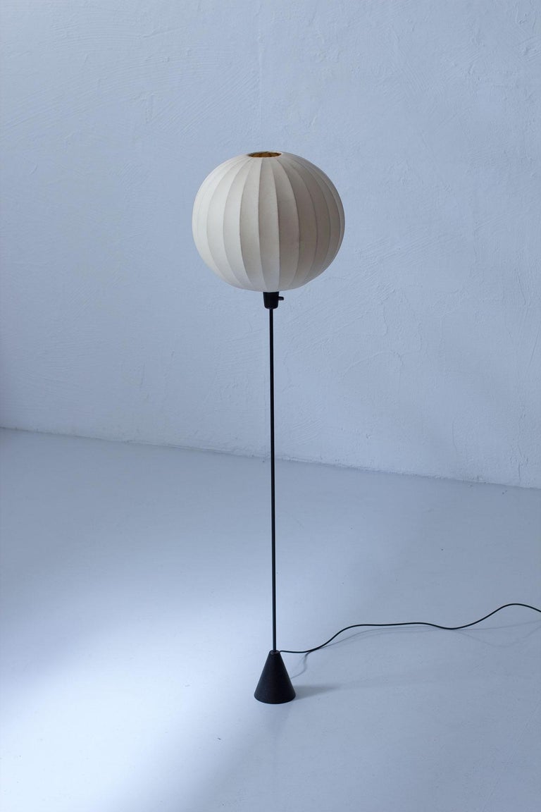 Striking Swedish floor lamp manufactured by ASEA Belysning during the 1950s.
The lamp is made from a cocoon (sprayed plastic technique) shade with a
cast iron base and a metal stem. It provides a warm light.
New electricity with original light