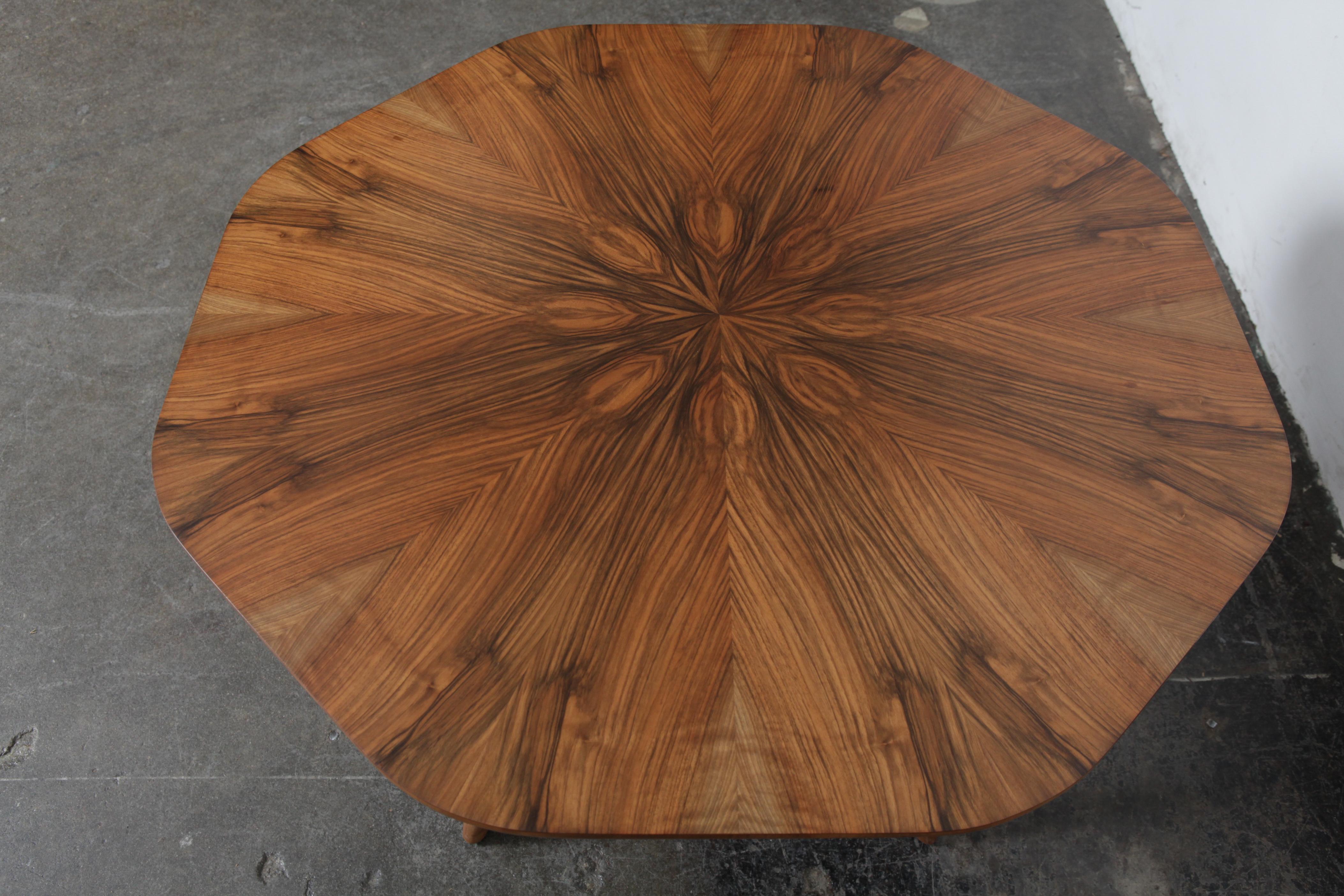 Swedish 1950s rosewood octagonal coffee table with beautiful sunburst grain pattern and cross support base, newly refinished in lacquer.